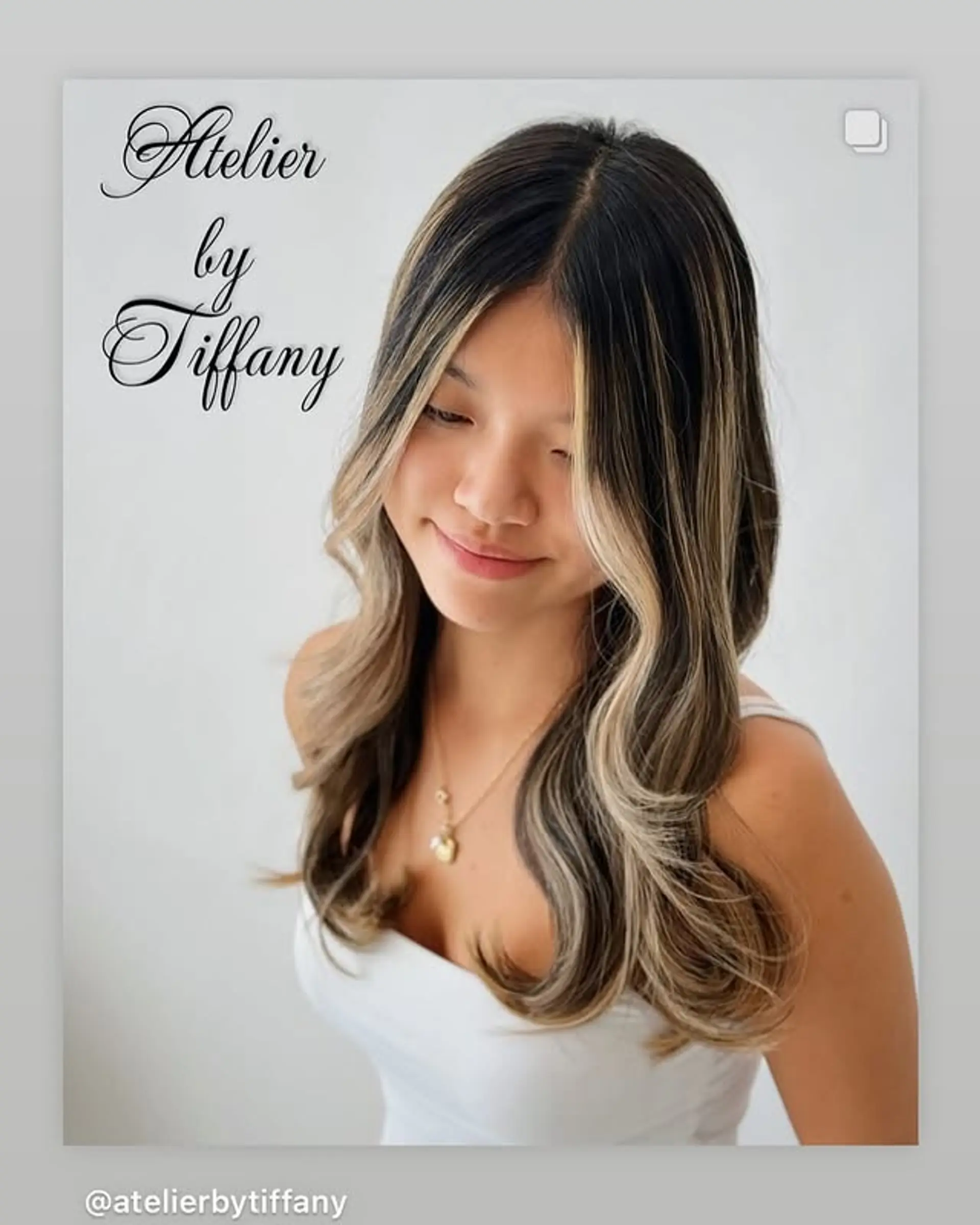 Long wavy hair with face-framing blonde highlights. 1