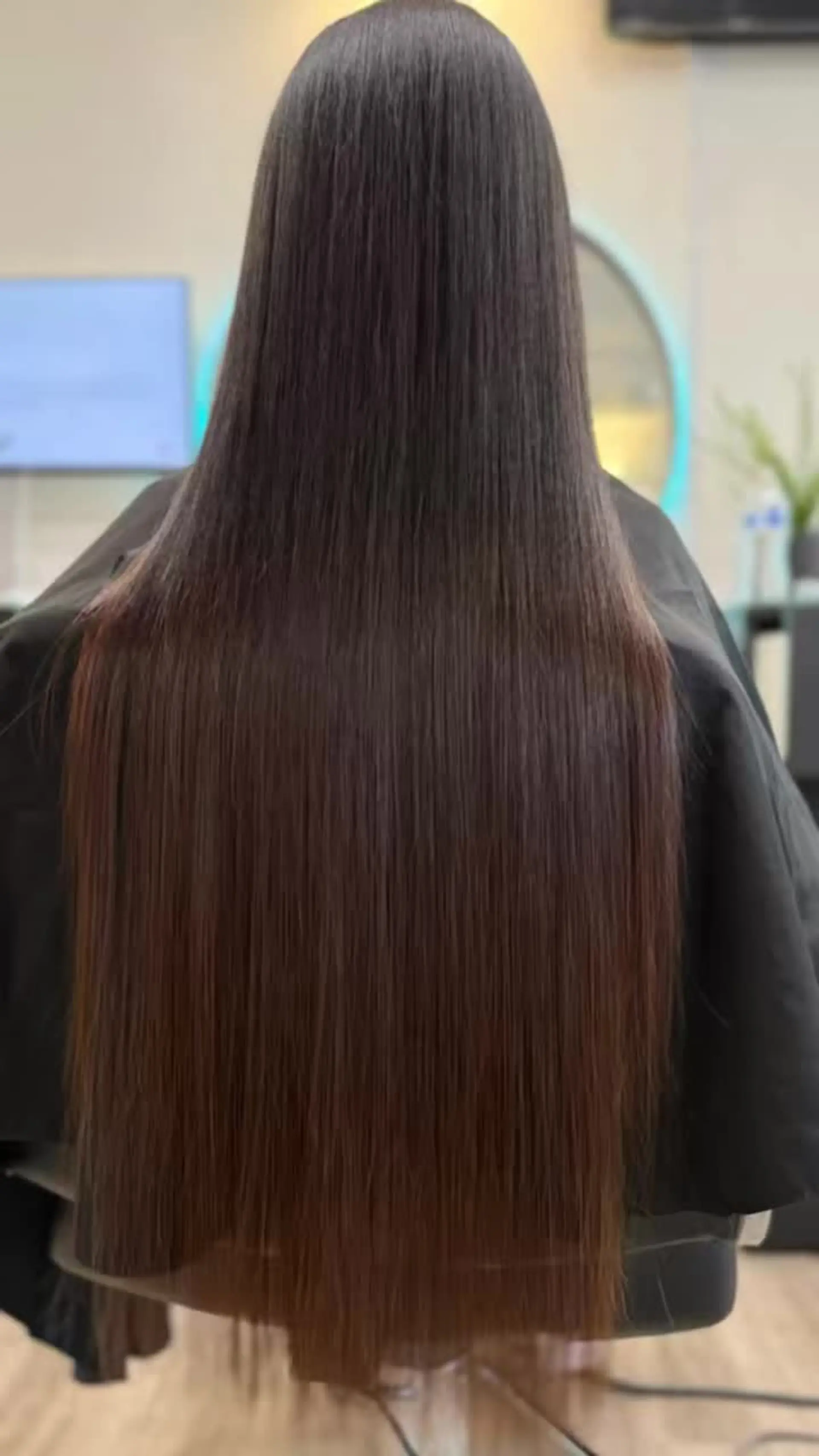 Ultra-long, pin-straight hair with a high-shine, sleek finish cascading smoothly down the back. 1