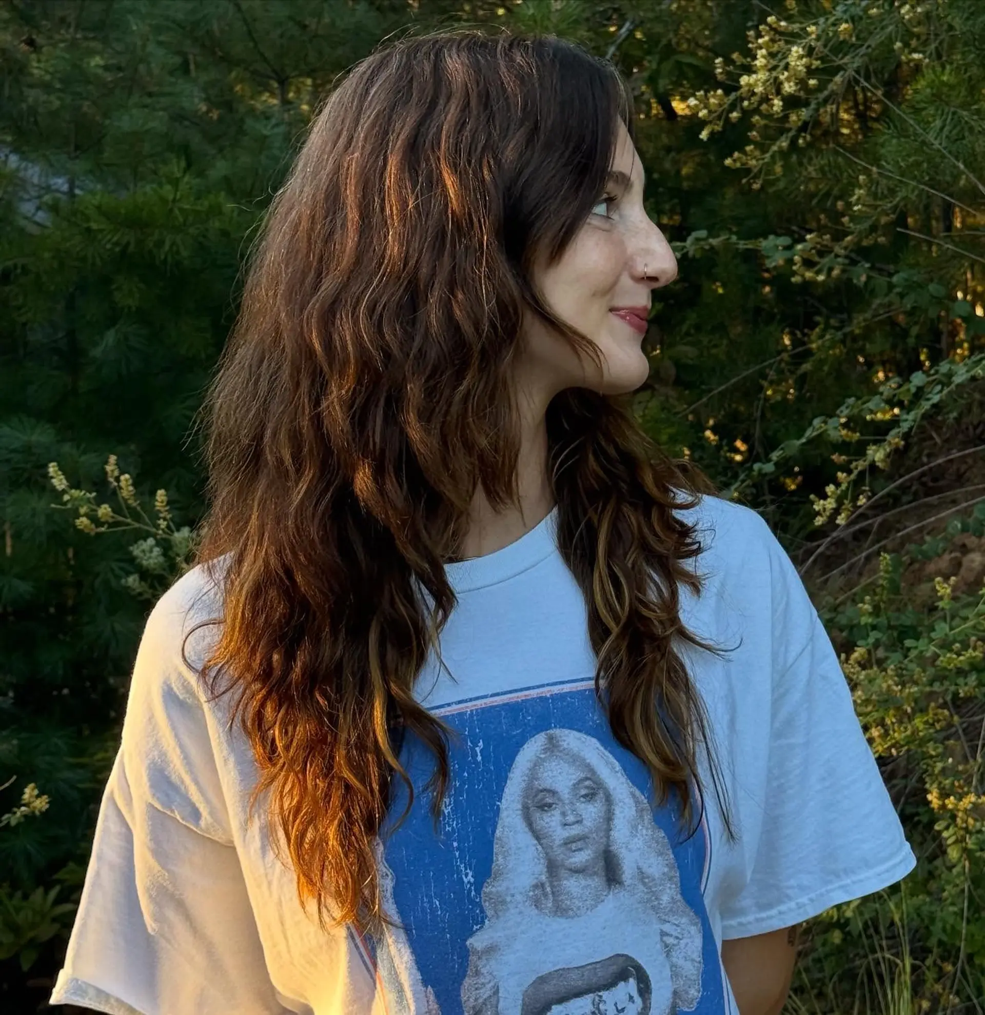 Long, wavy brunette hair with subtle golden highlights. 1