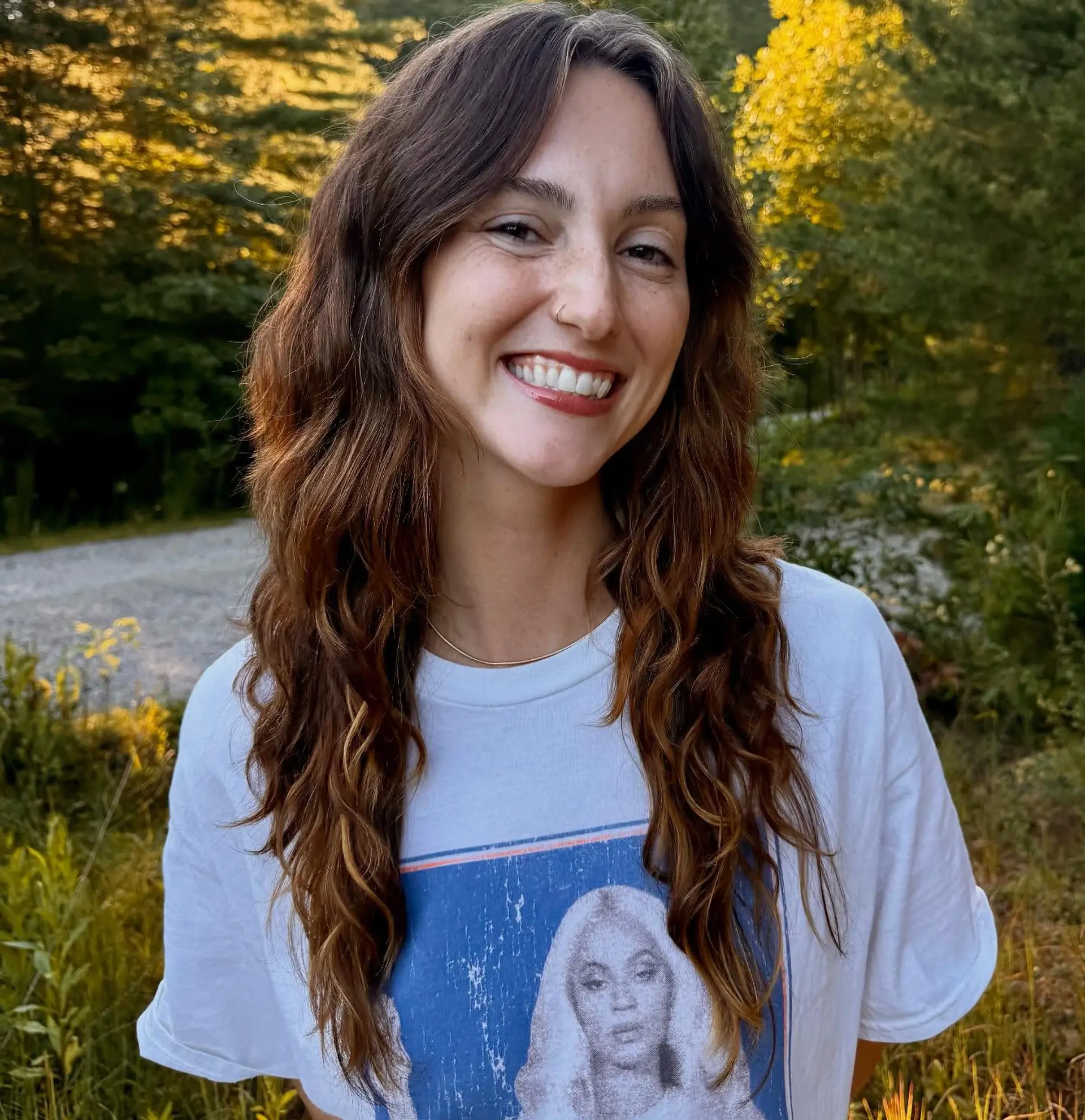 Long, wavy brunette hair with subtle golden highlights. 2