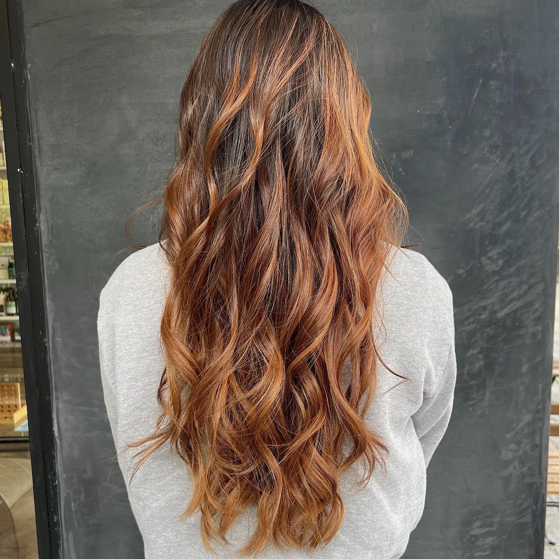 Long wavy hair with a copper balayage. 1