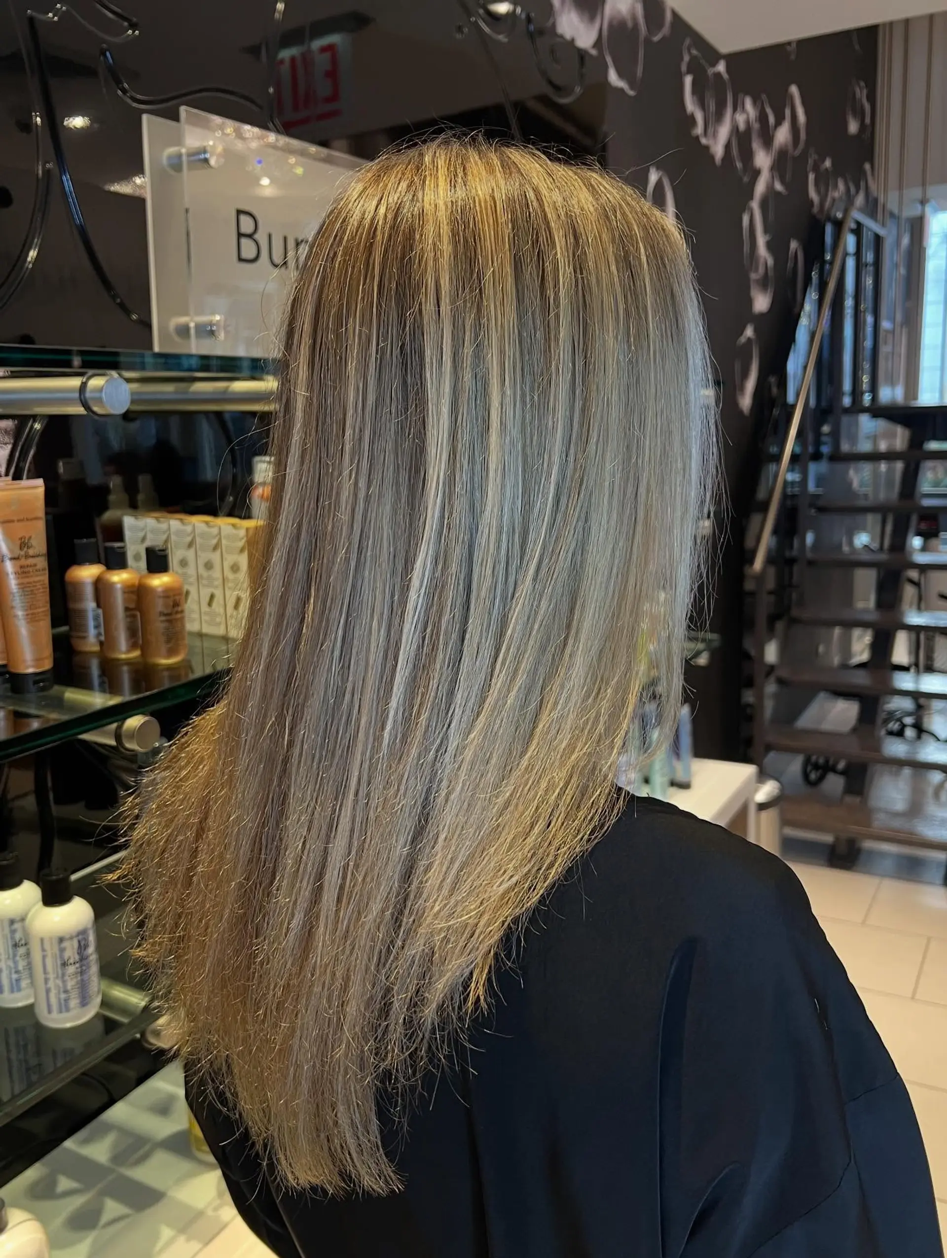 Long, straight hair featuring a soft, blended blonde balayage with multi-tonal dimensional highlights. 1