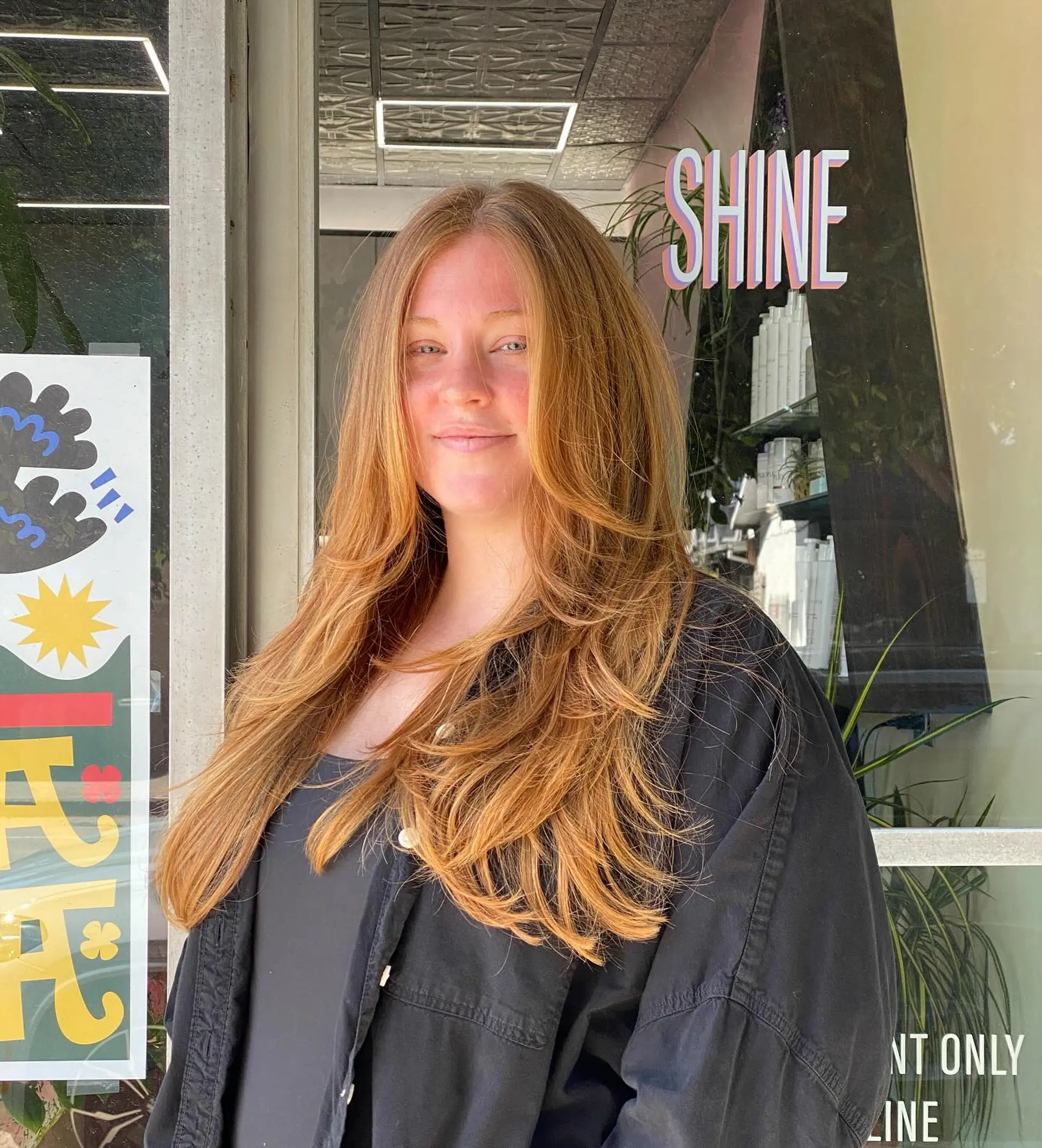 A long, feathered butterfly haircut featuring soft, face-framing layers and a bouncy blowout. 1