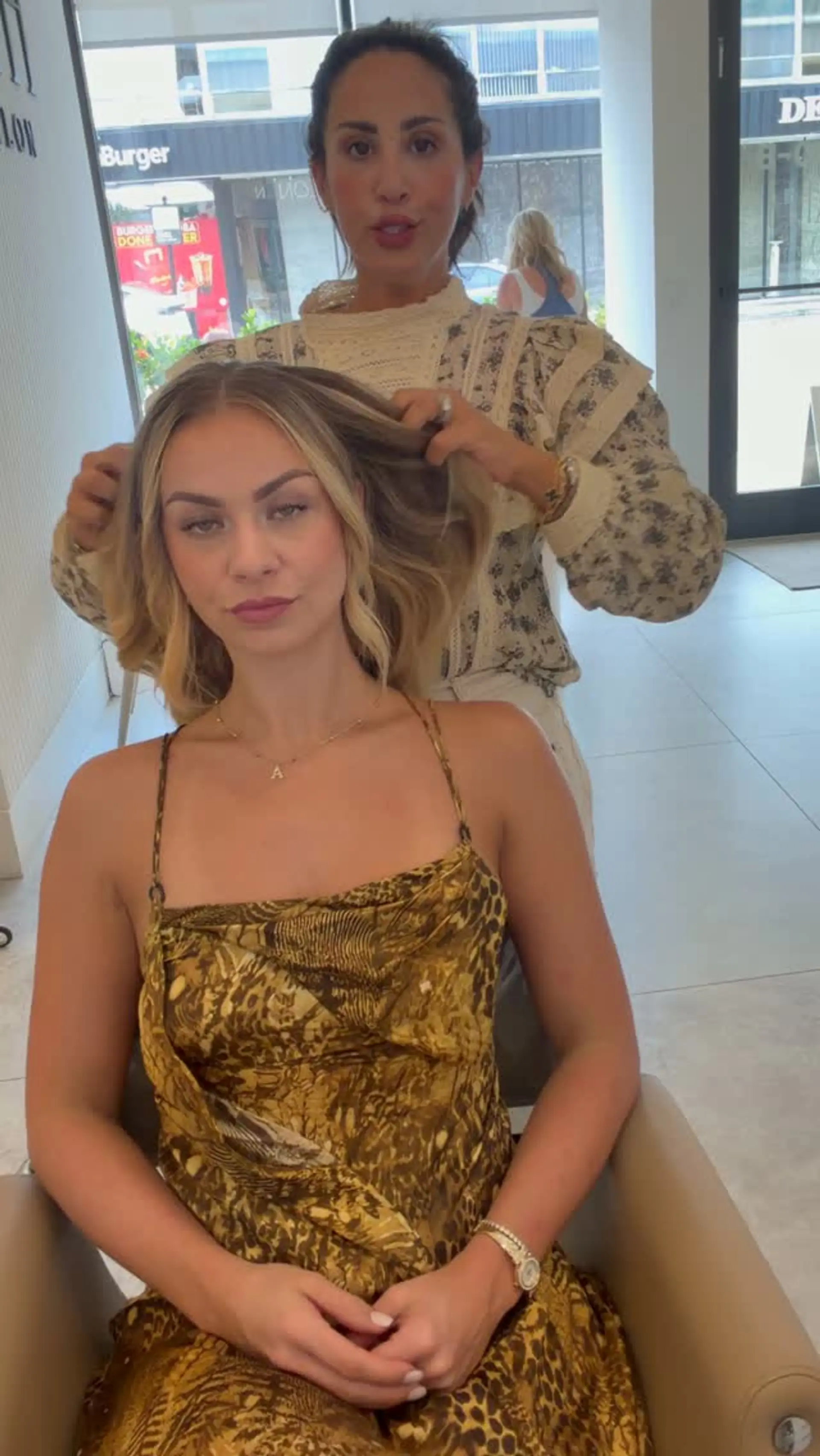 Medium-length dimensional blonde hair featuring bright face-framing highlights, a blended root tap, and soft salon waves. 1