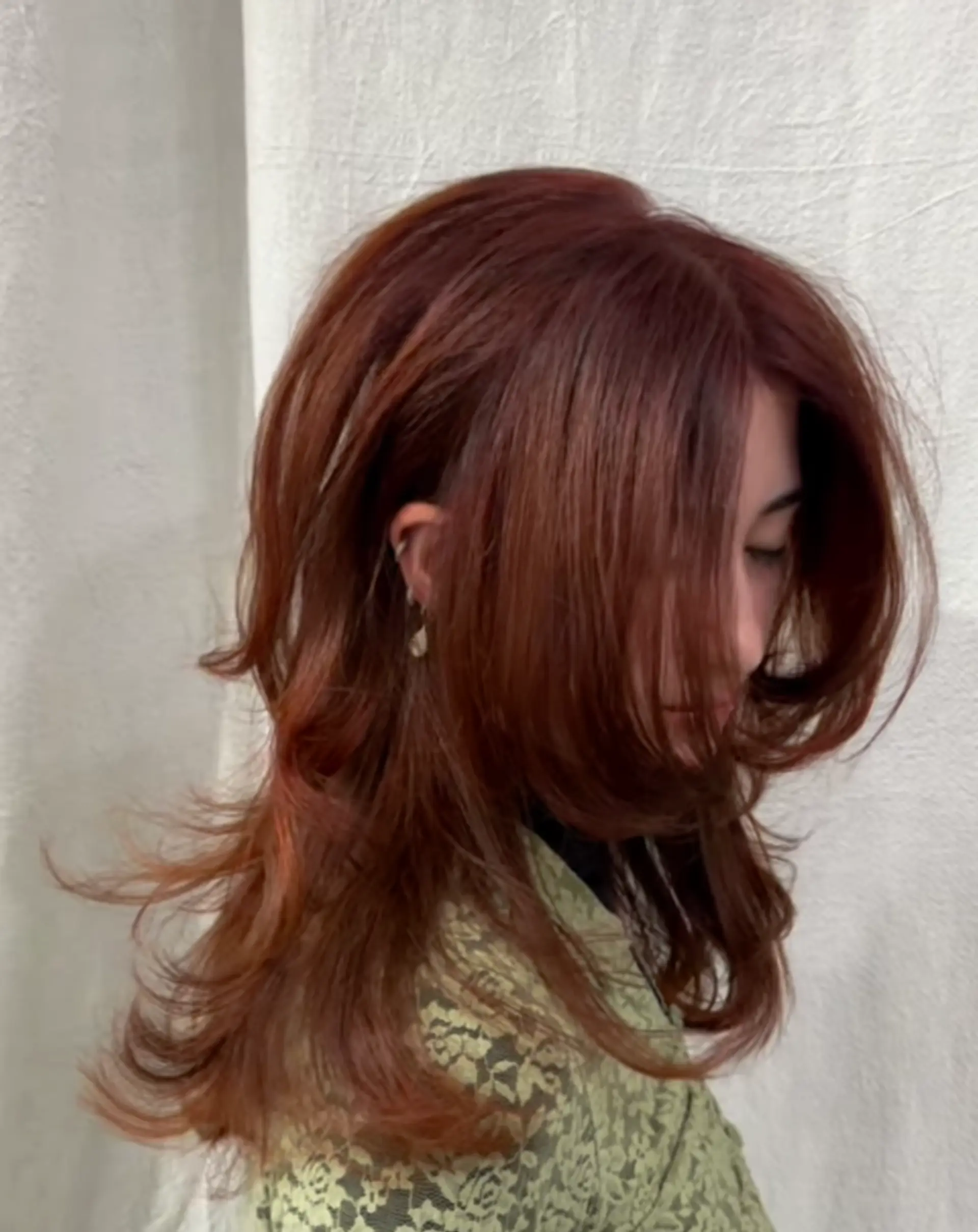 Long, wavy, copper auburn hair with voluminous layers and feathered ends, featuring movement and face-framing waves. 1