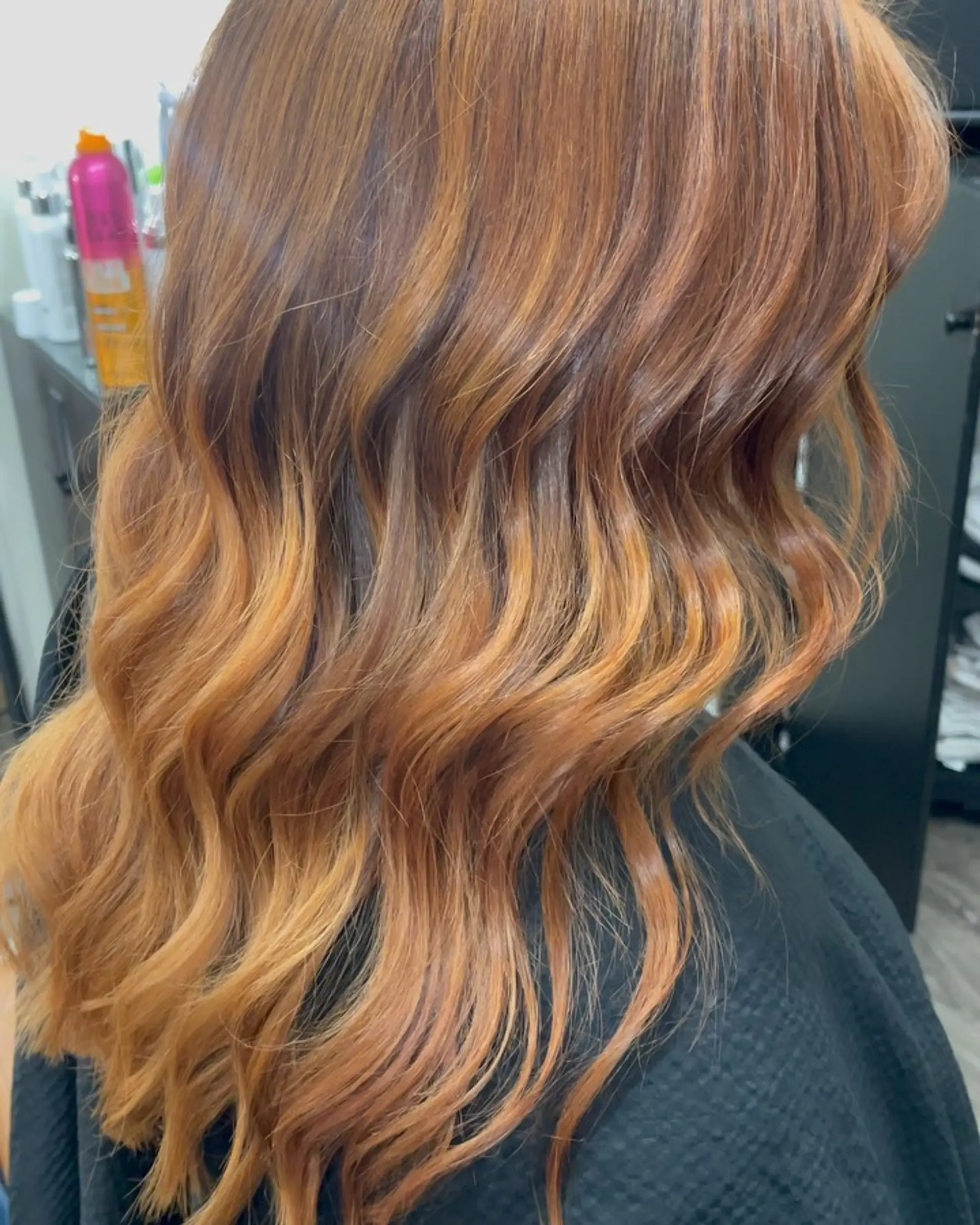 Long dimensional copper hair styled with soft, loose waves and glowing lighter golden-copper ends. 1