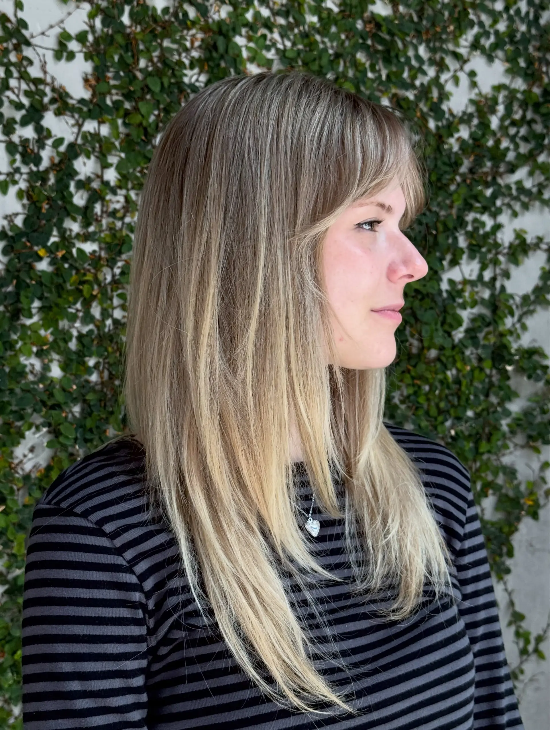 Long, straight ash blonde hair featuring multi-dimensional highlights and soft wispy bangs. 1