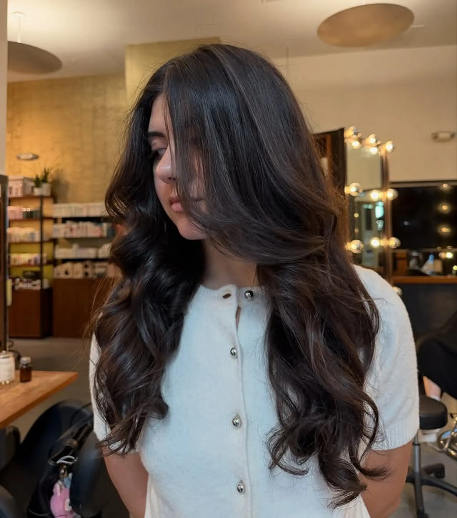 A long, wavy hairstyle with soft layers that create a bouncy and voluminous look. 1