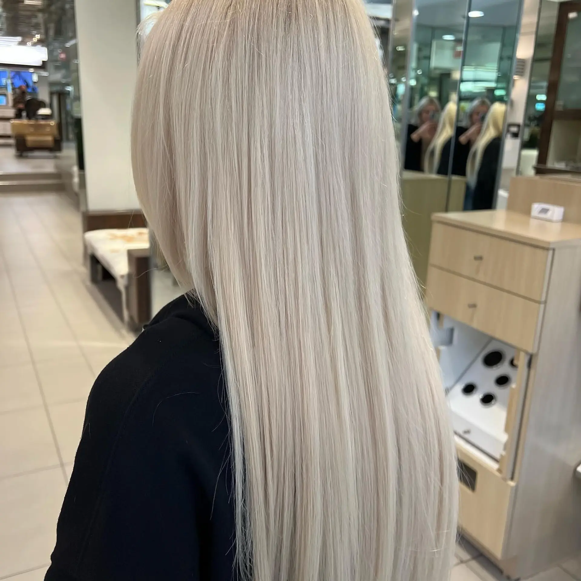Ultra-long, sleek straight hair finished in a seamless, luminous platinum blonde tone. 1