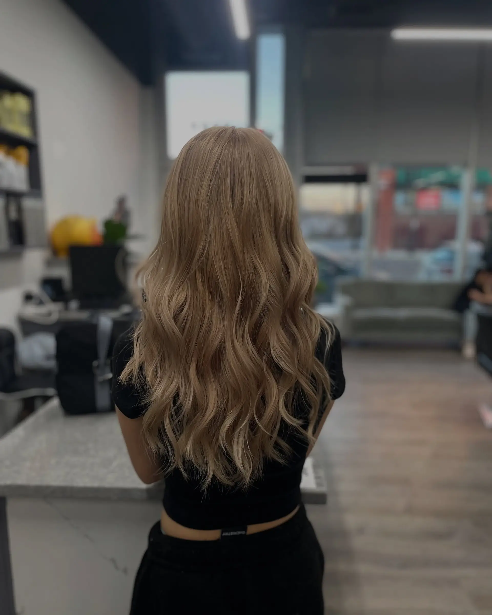 Long, bronde wavy hair with soft beachy waves and face-framing layers. 1