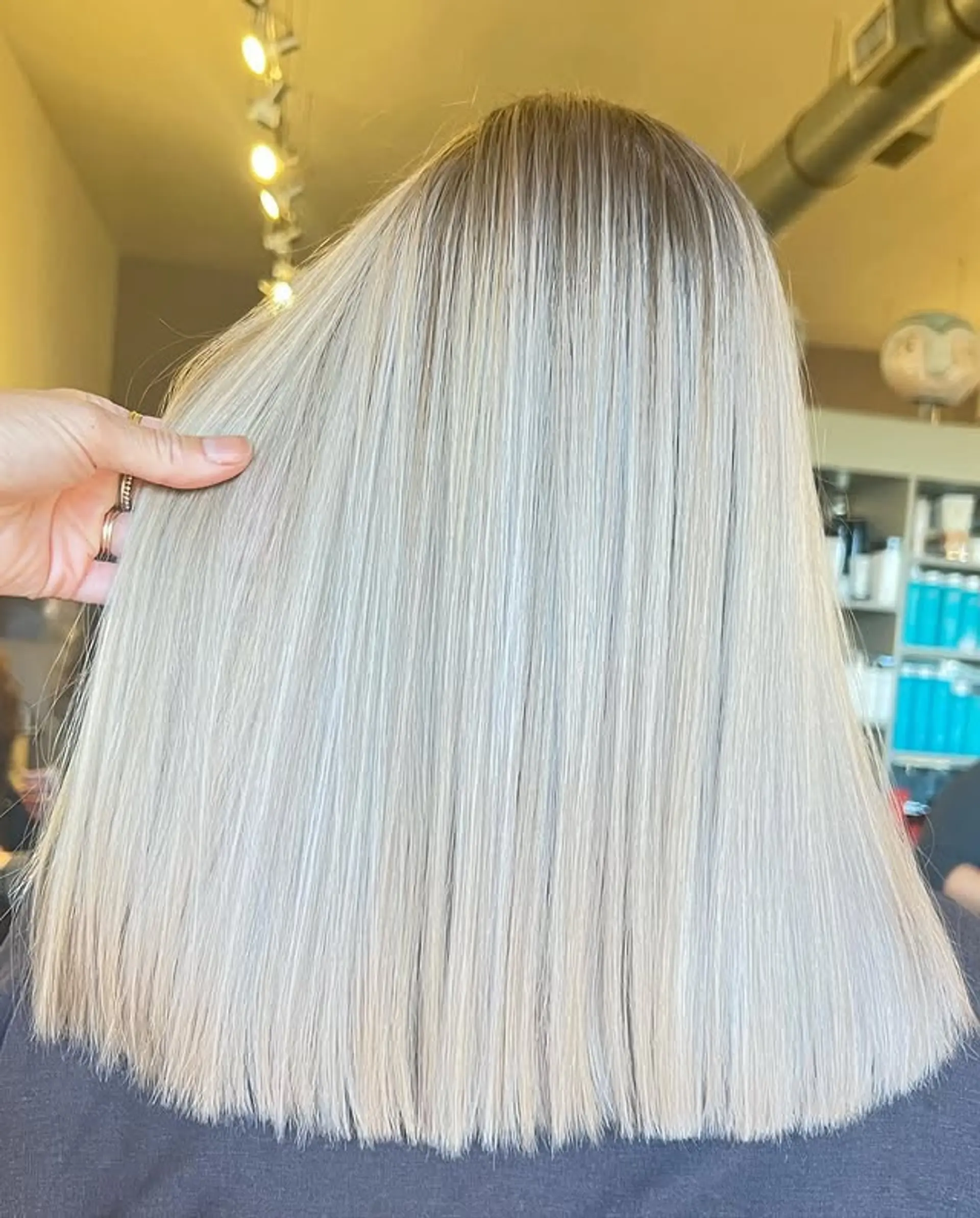 A straight lob hairstyle with icy blonde color. 1