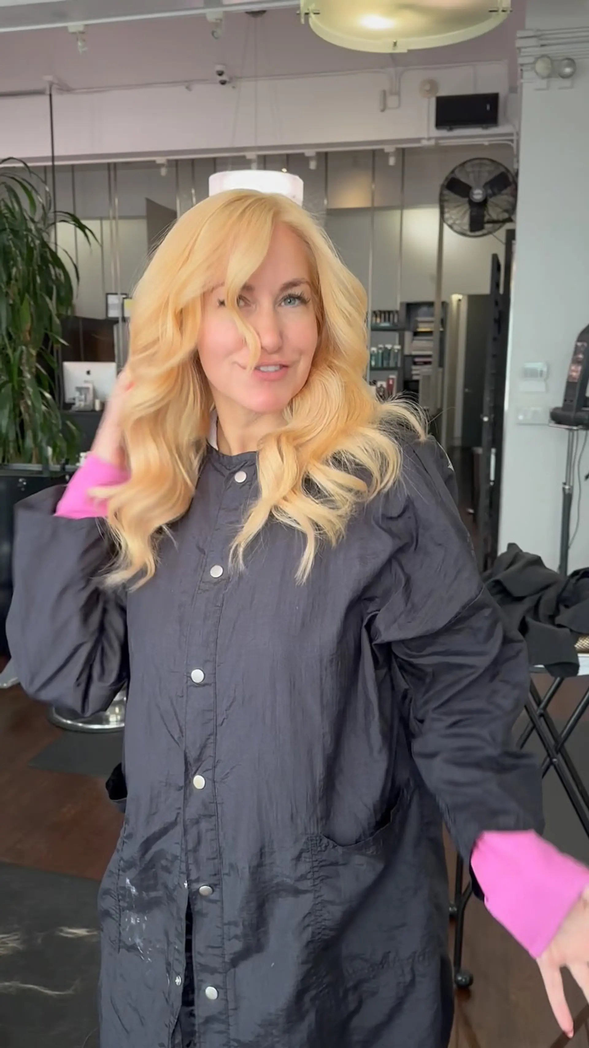 Voluminous, warm golden blonde hair styled into full, bouncy loose waves with soft face-framing layers. 1