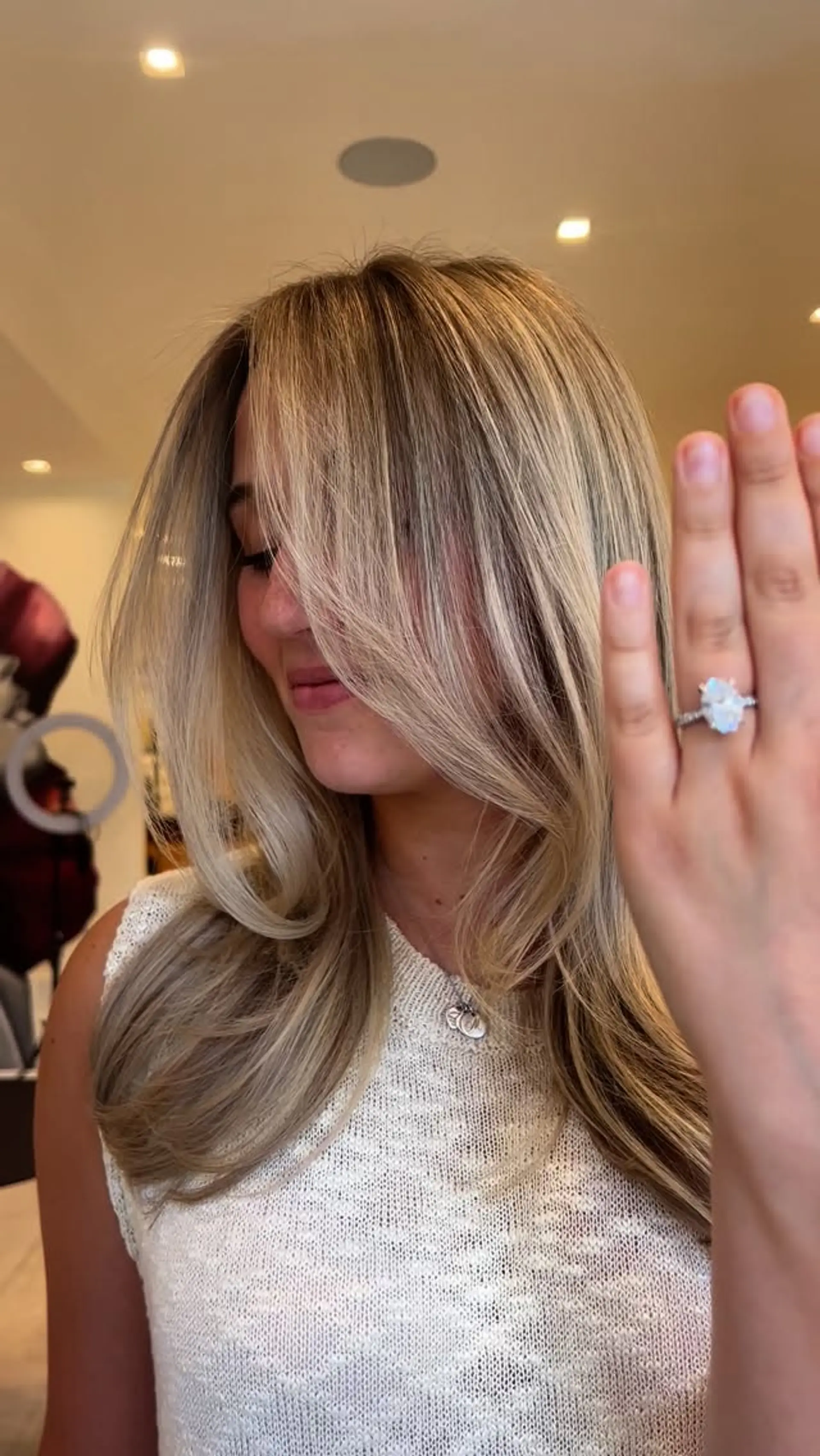 Dimensional blonde balayage styled in a soft blowout with long, sweeping face-framing layers. 1