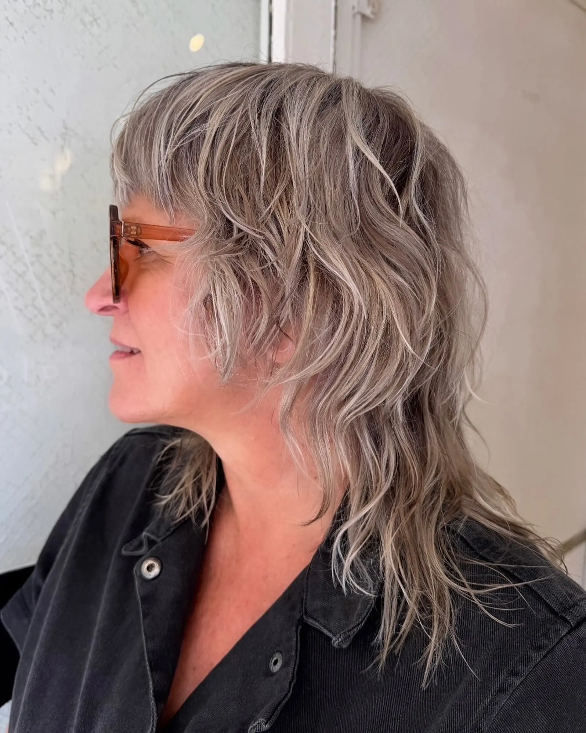 Medium-length wavy hair with silver and ash blonde tones, textured layers, and natural waves. 2