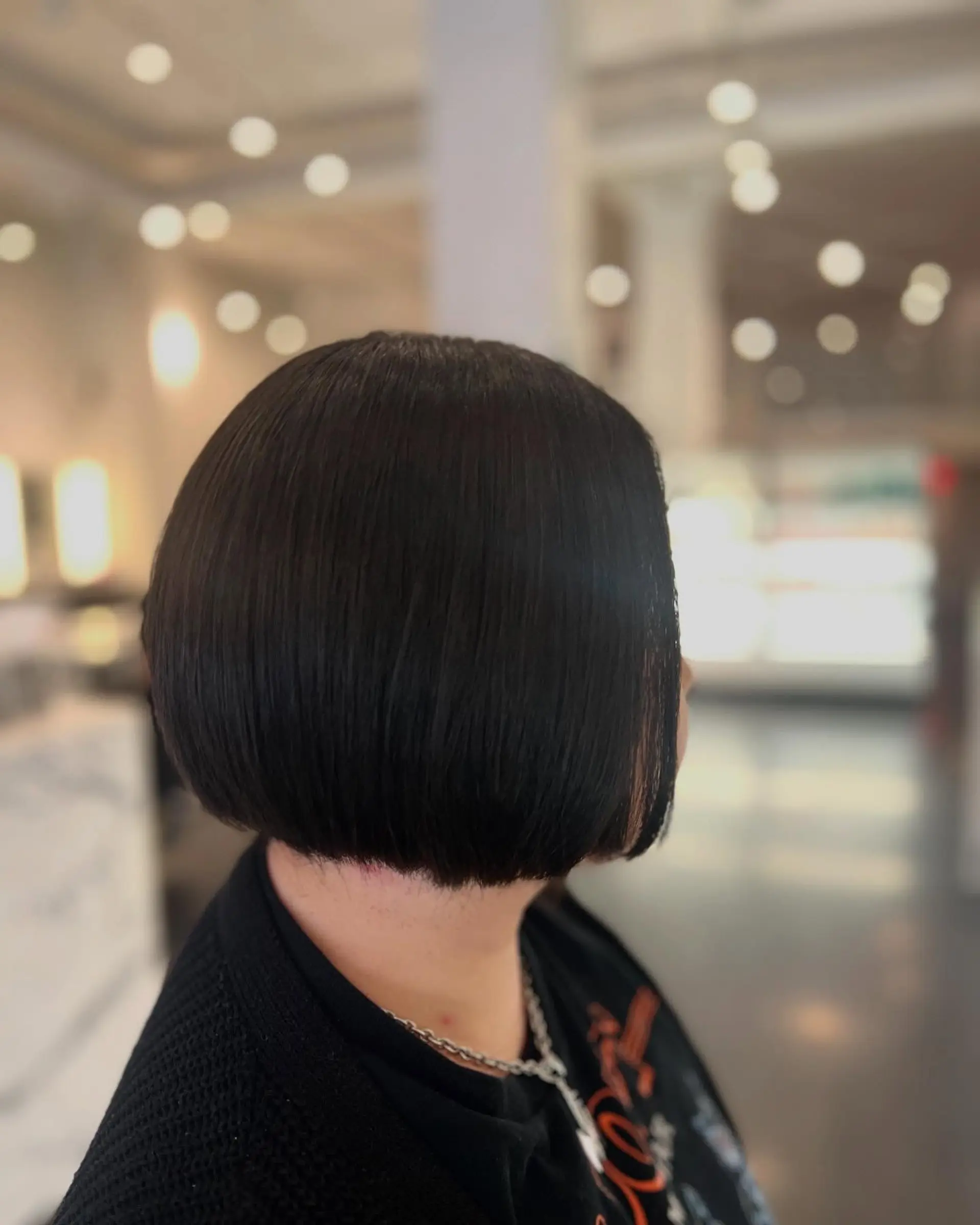A sleek, one-length blunt bob cut straight around the jawline with a sharp, clean silhouette. 1