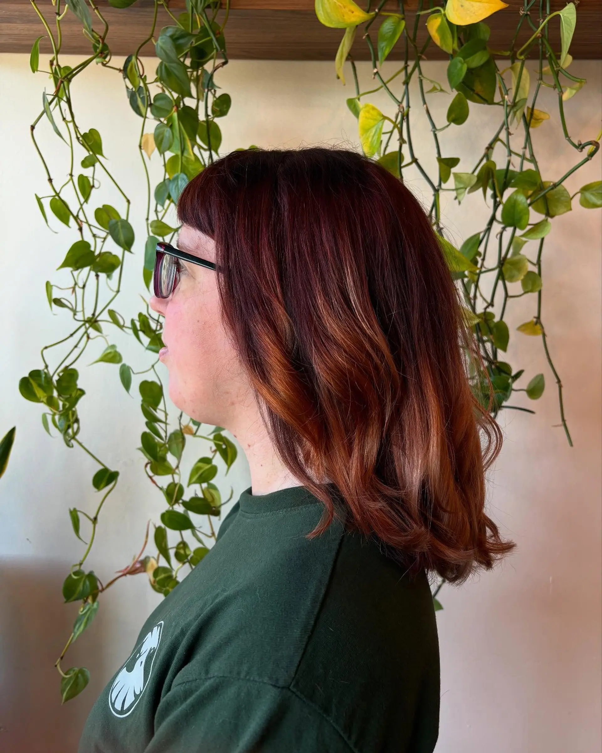 Medium-length rich copper color melt with blunt bangs and loose, wavy ends. 1
