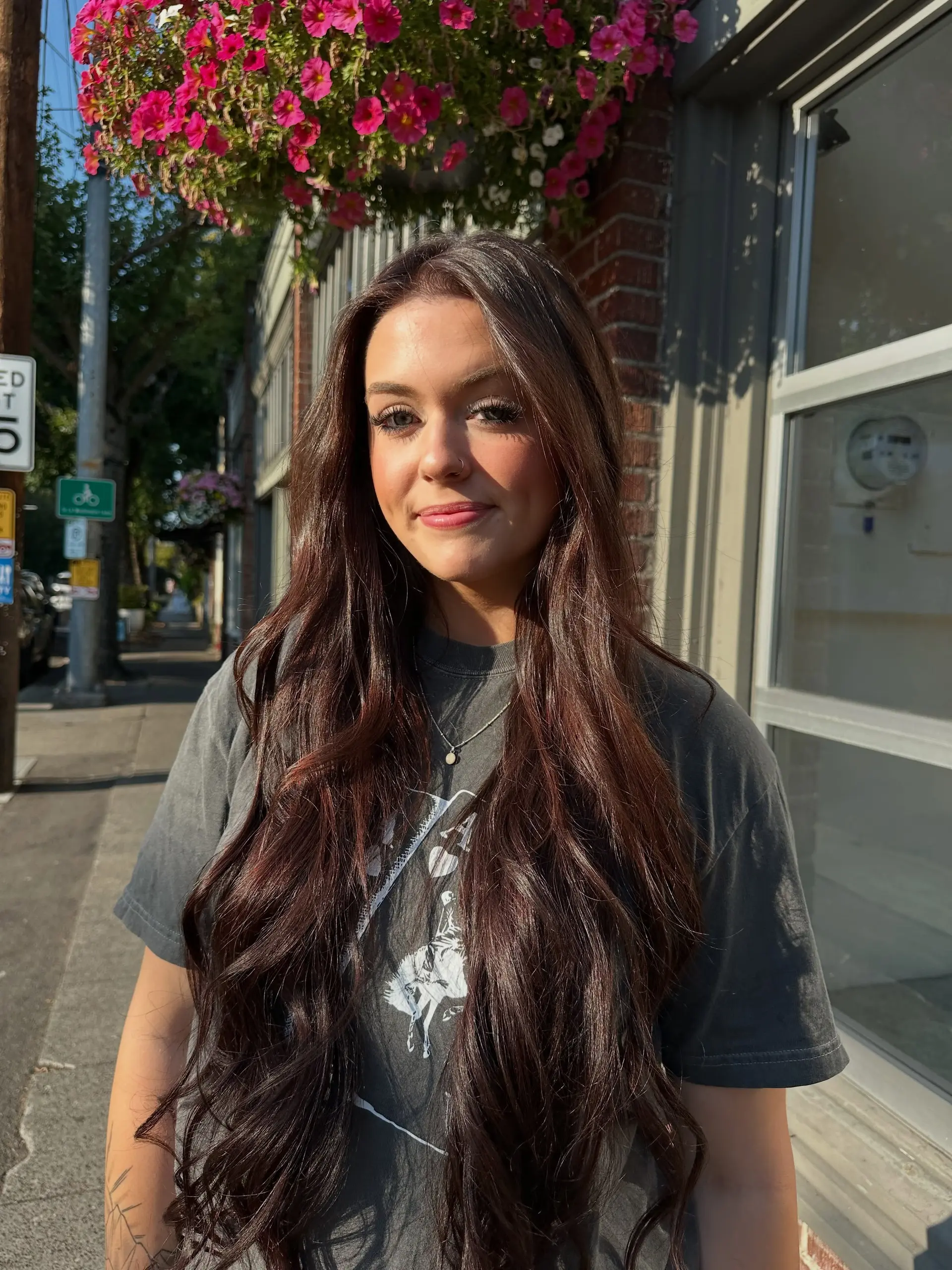 Long, flowing dark brunette hair styled with soft, cascading waves and a natural center part. 1