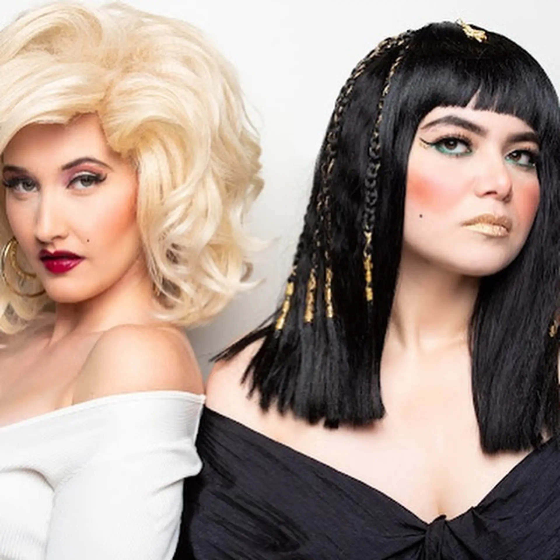 A themed duo look featuring voluminous retro platinum blonde curls beside a sleek black lob with blunt bangs and gold-accented braids. 1