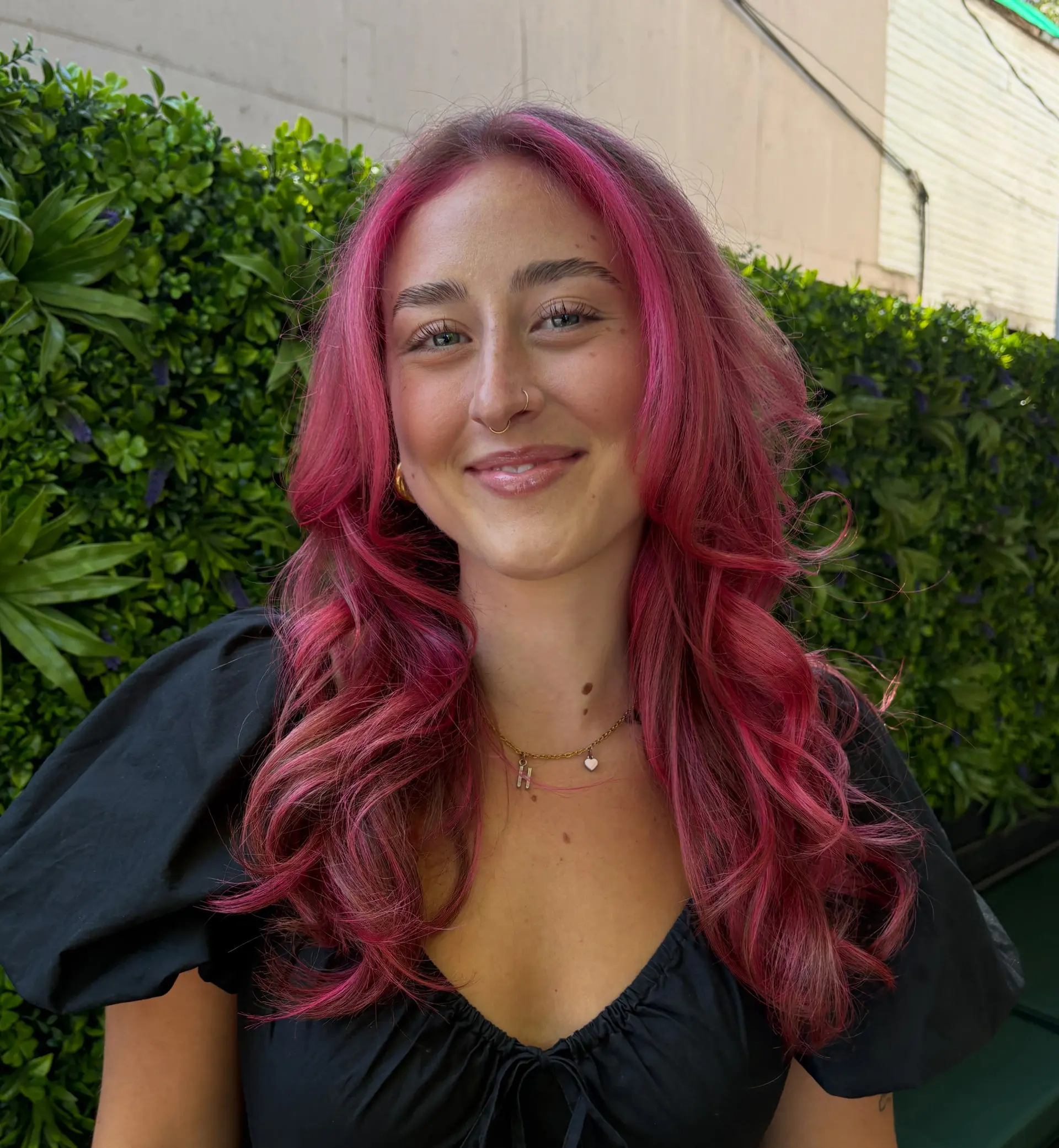 Vibrant hot pink long hair styled with layered waves and face-framing curtain fringe. 1