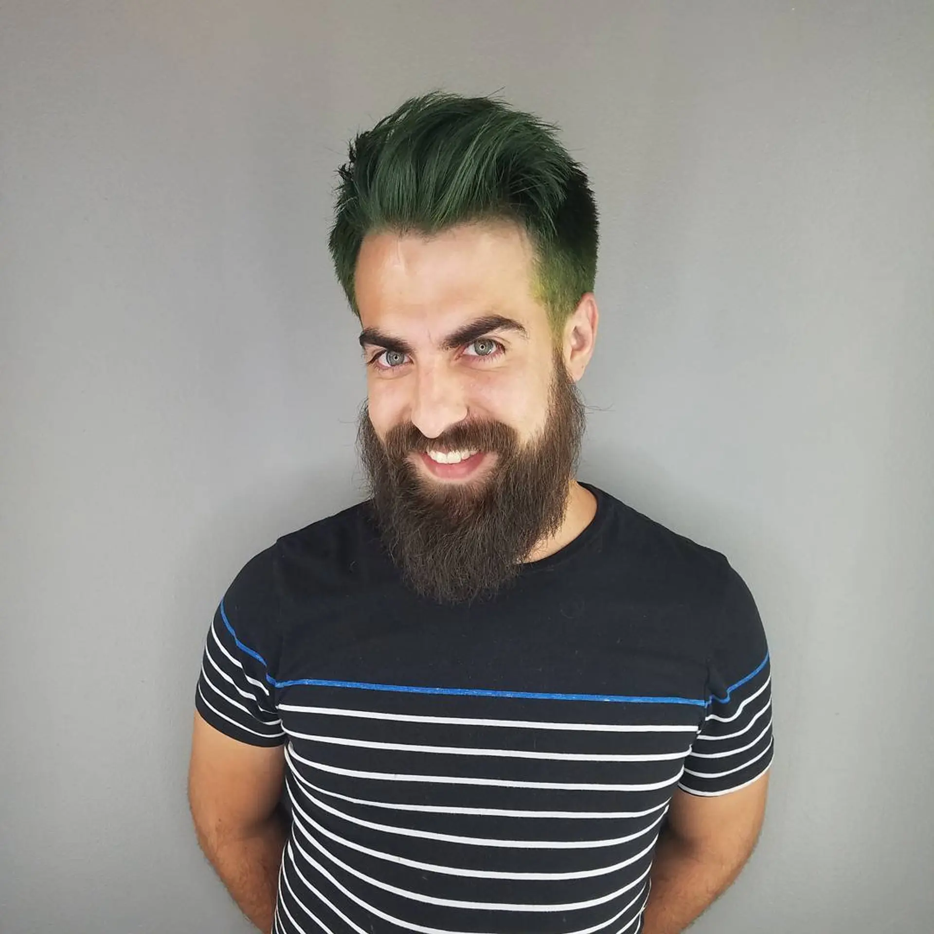 A men's short textured quiff haircut colored in a rich forest green tone. 1
