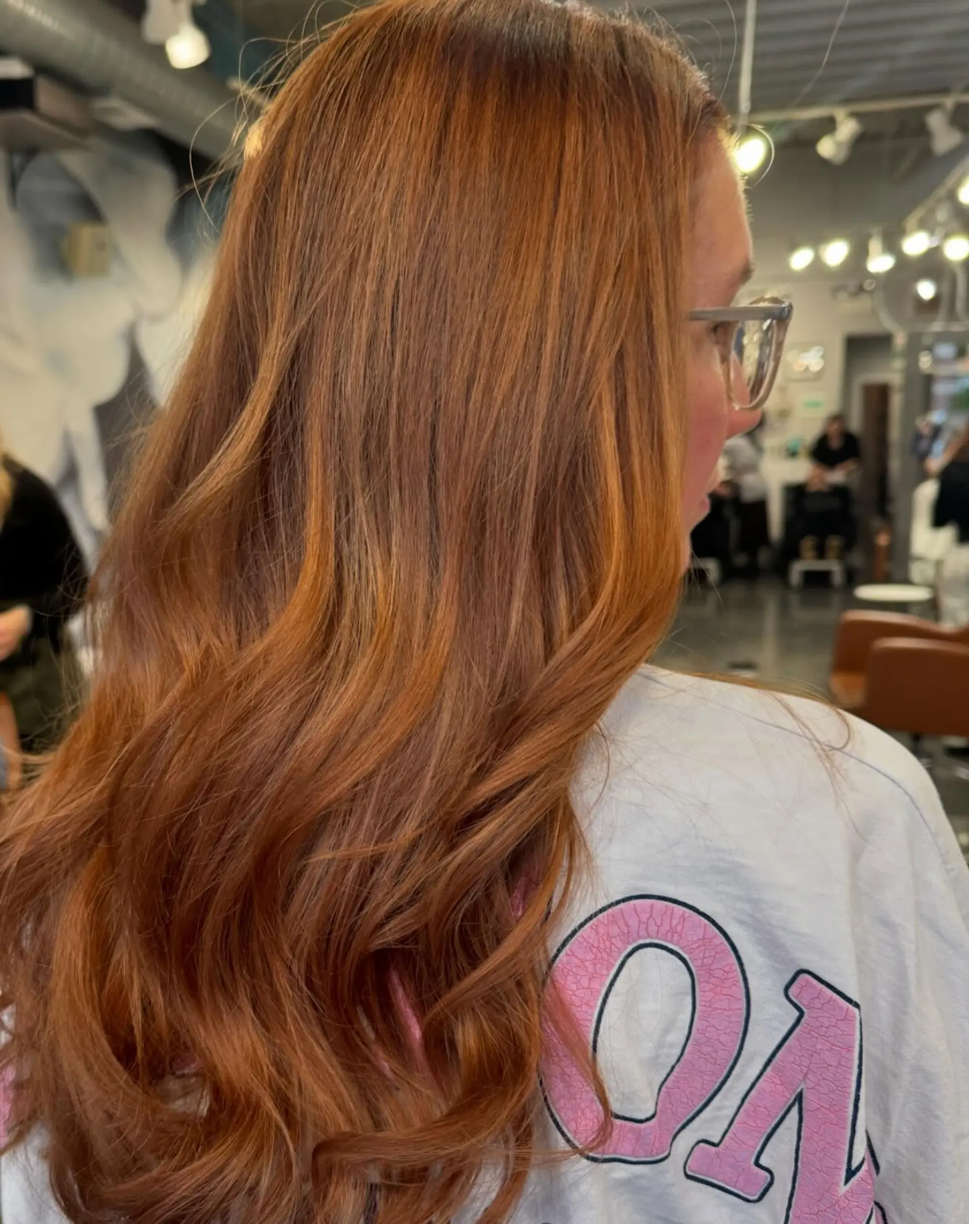 Long hair styled with loose waves, in a copper color with auburn lowlights 1