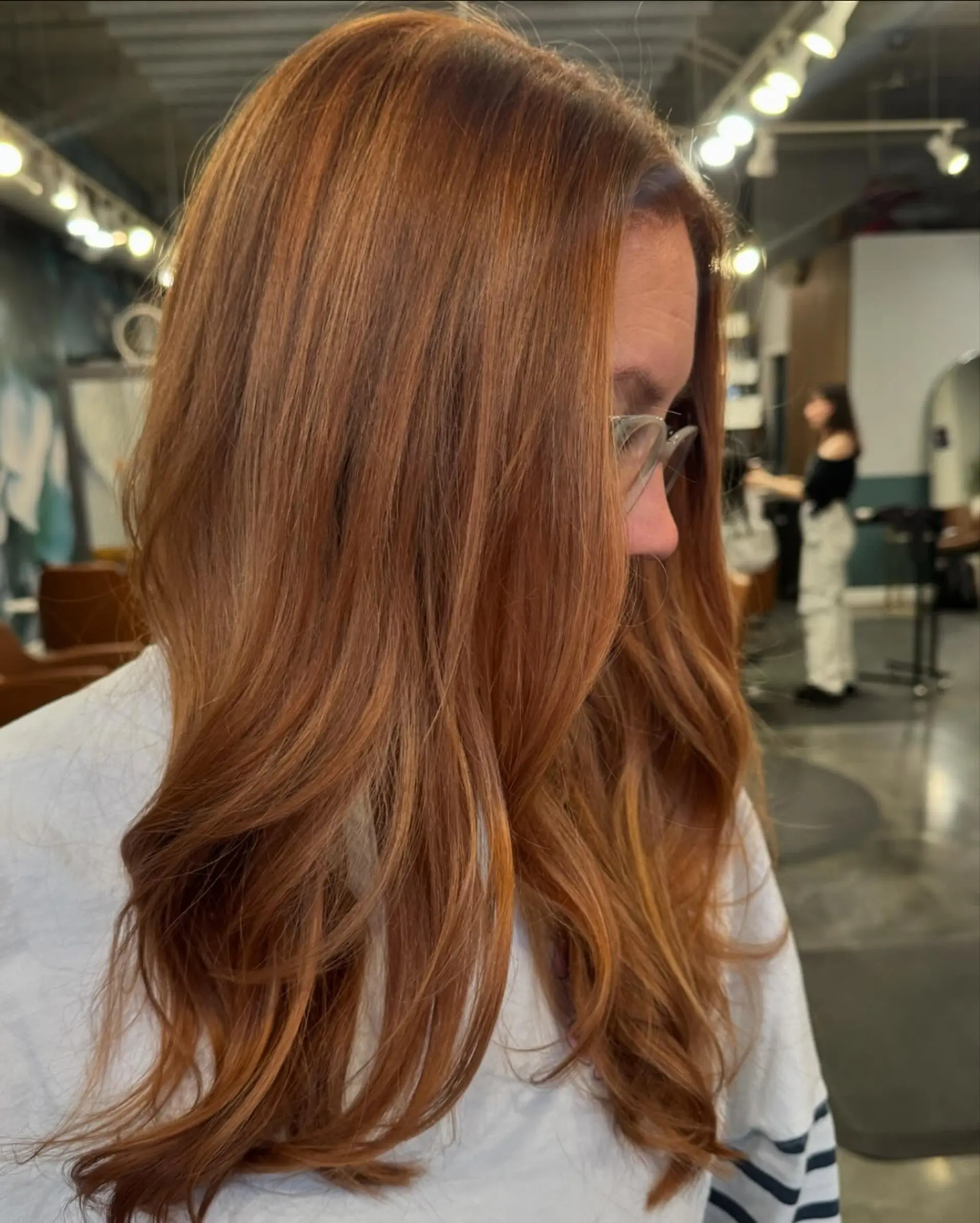 Long hair styled with loose waves, in a copper color with auburn lowlights 2