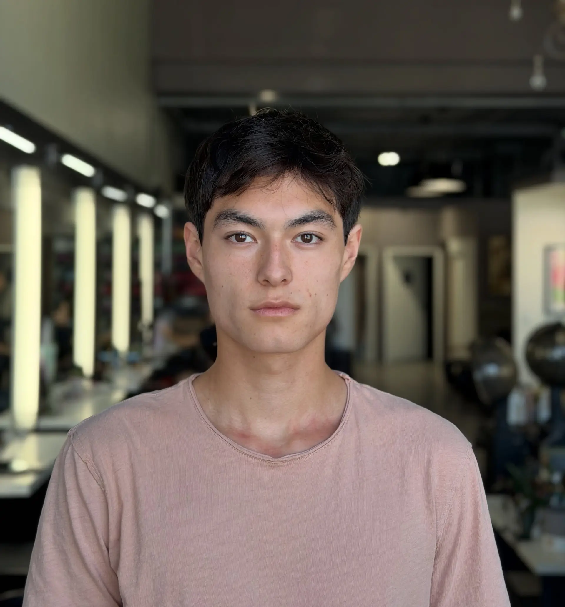 A clean, textured short men's haircut featuring light, piecey fringe and neat tapered sides. 1
