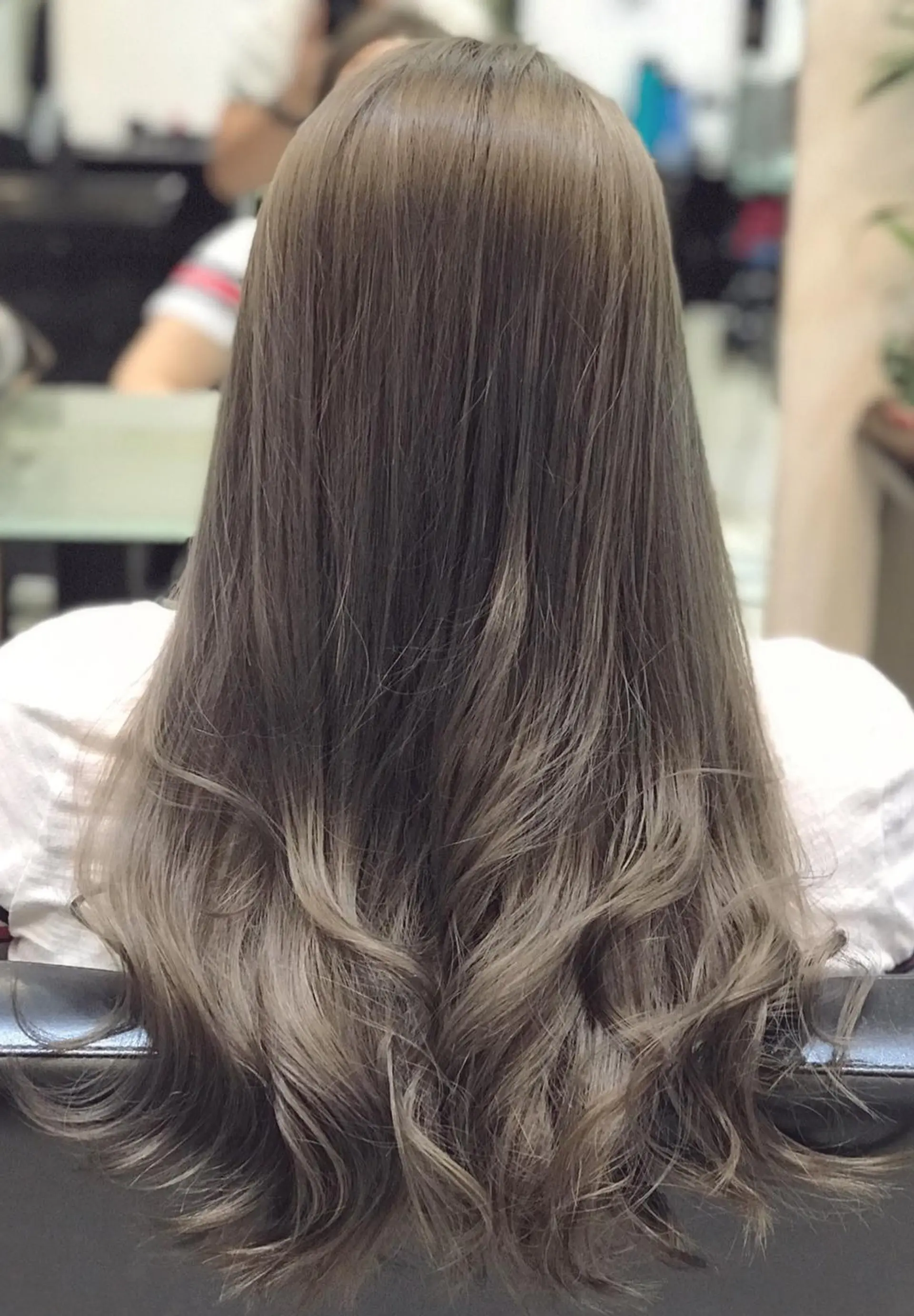 Long, straight hair styled into soft waves with an ash brown and blonde ombre. 1
