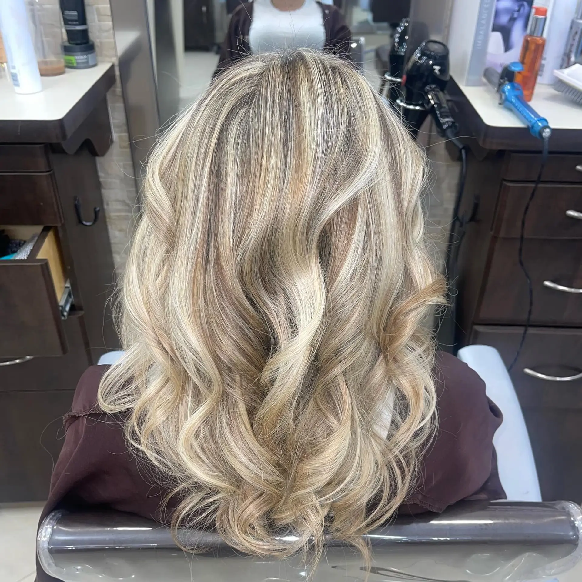 Long, wavy hair with a stunning blonde balayage, creating a dimensional and beachy look. 1
