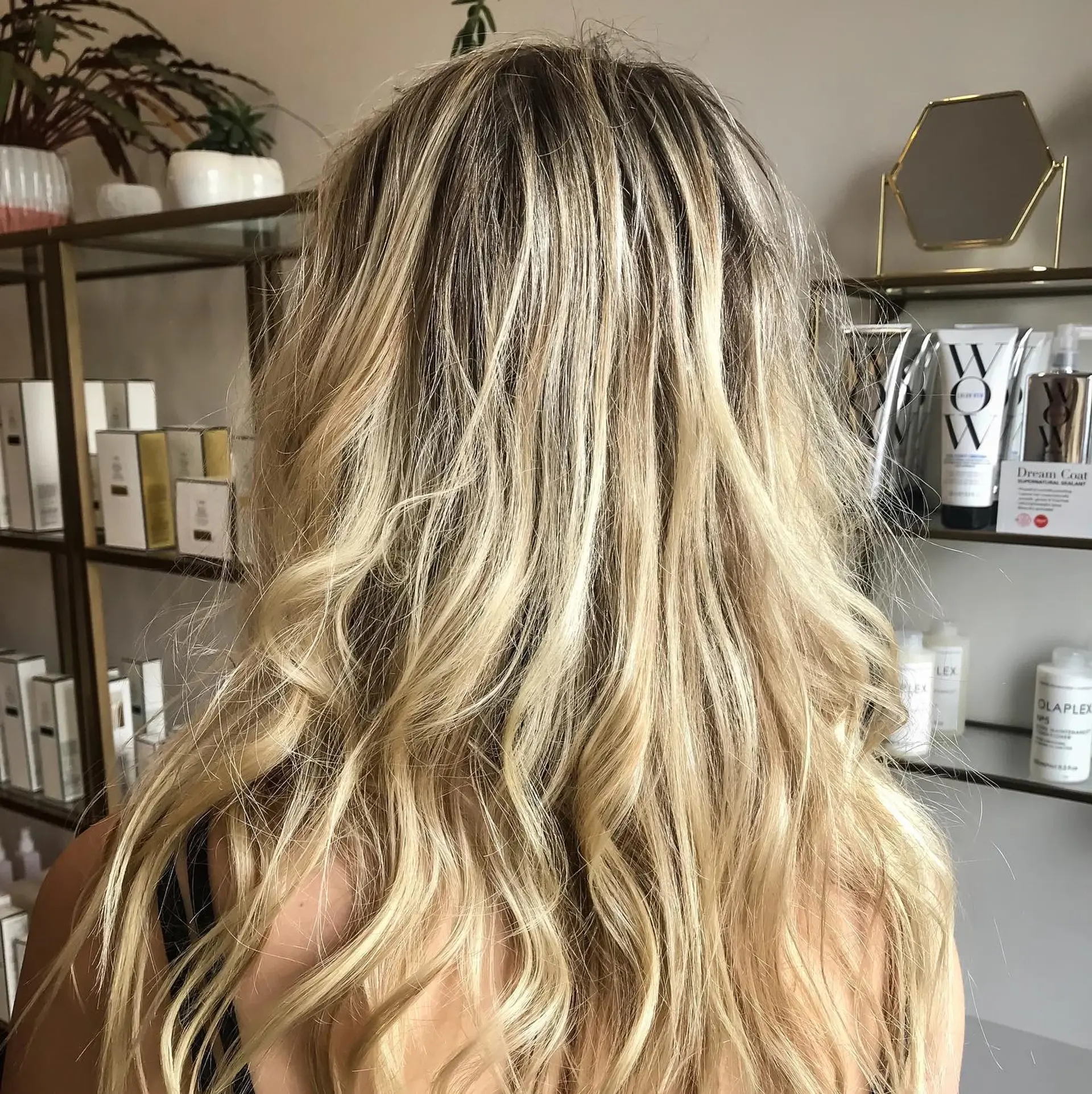 Long hair featuring dimensional blonde highlights over a shadowed root, styled in textured, loose waves. 1