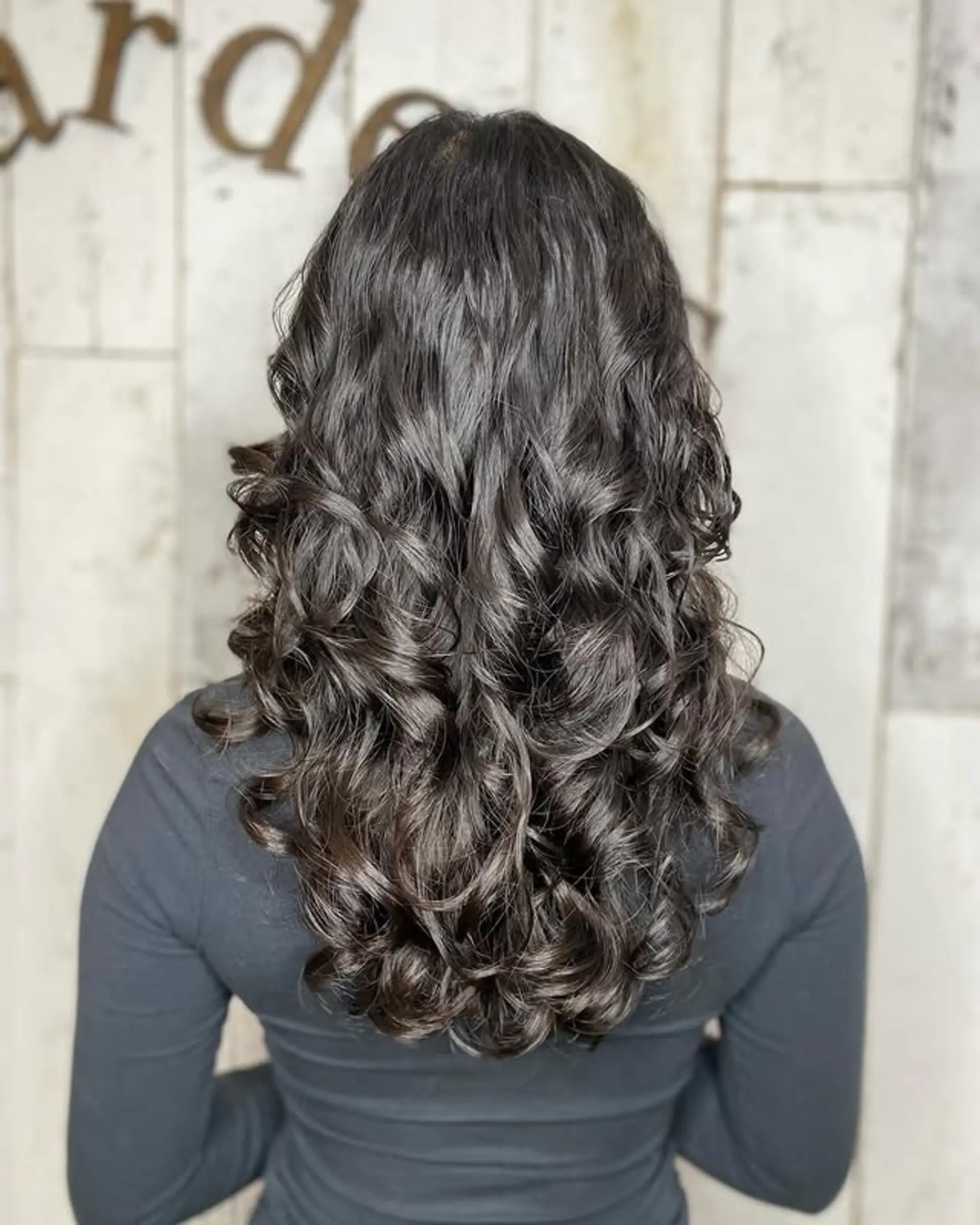 Long layered curly hair with defined curls. 1