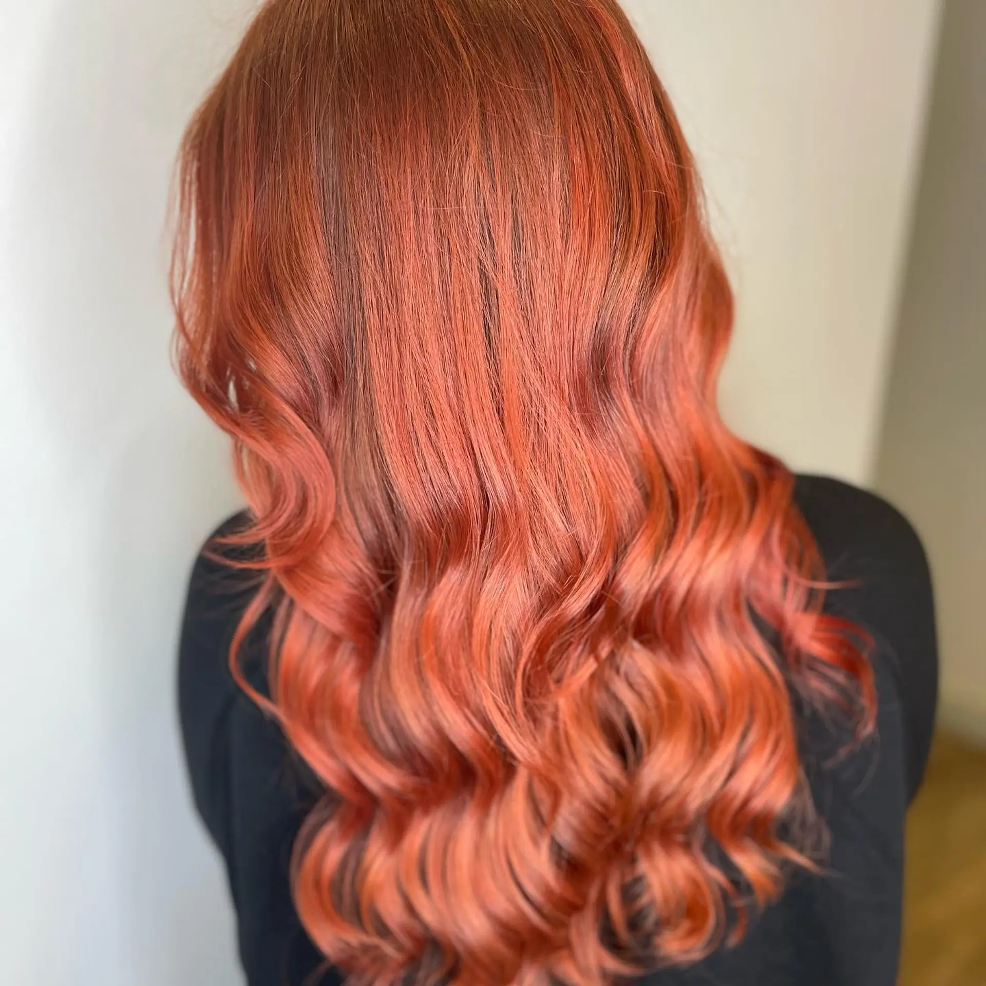 Rich, vibrant copper red hair styled with soft, cascading curls through the mid-lengths and ends. 1