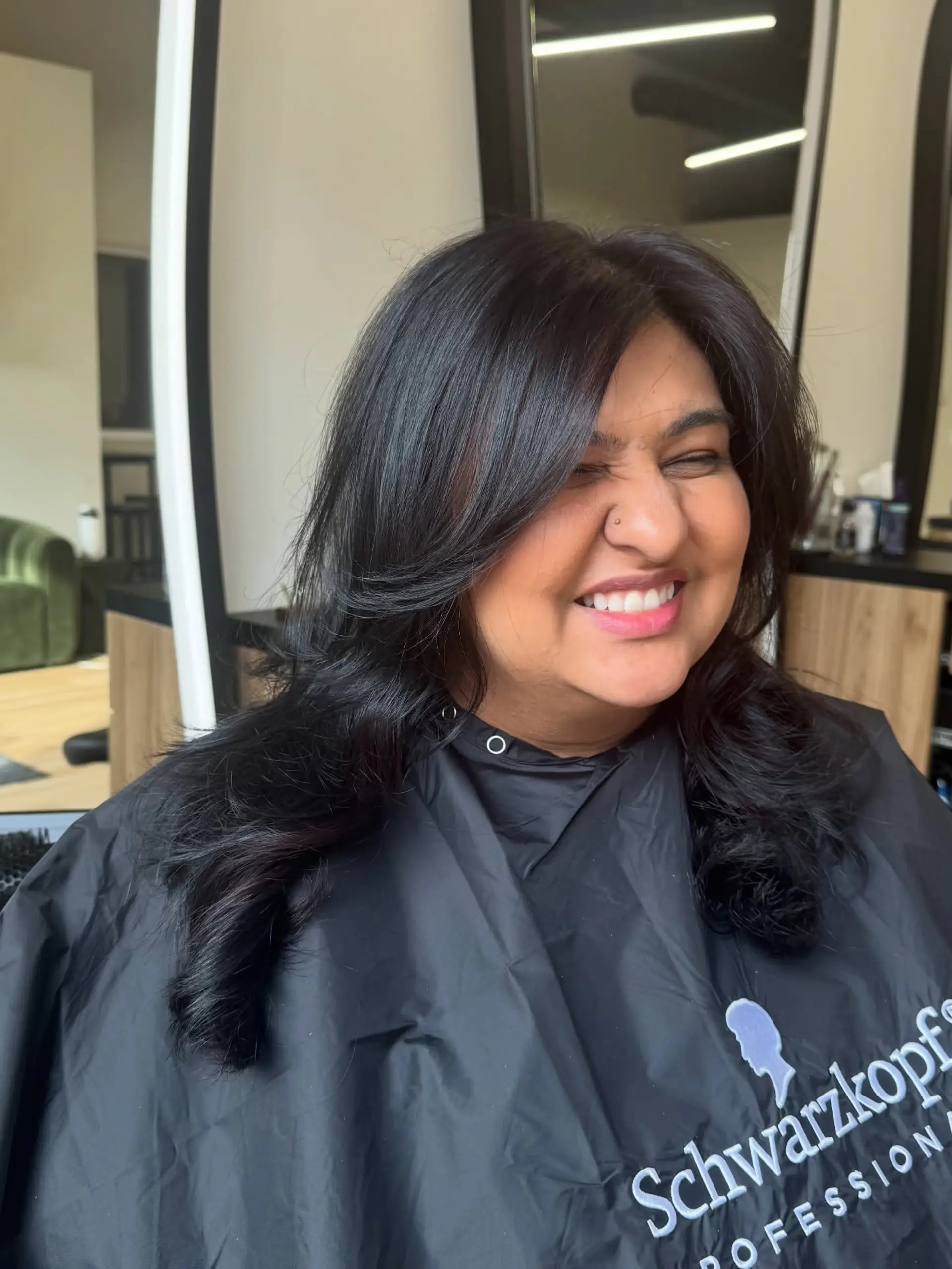 Voluminous long black hair styled with face-framing layers and soft curls at the ends. 1
