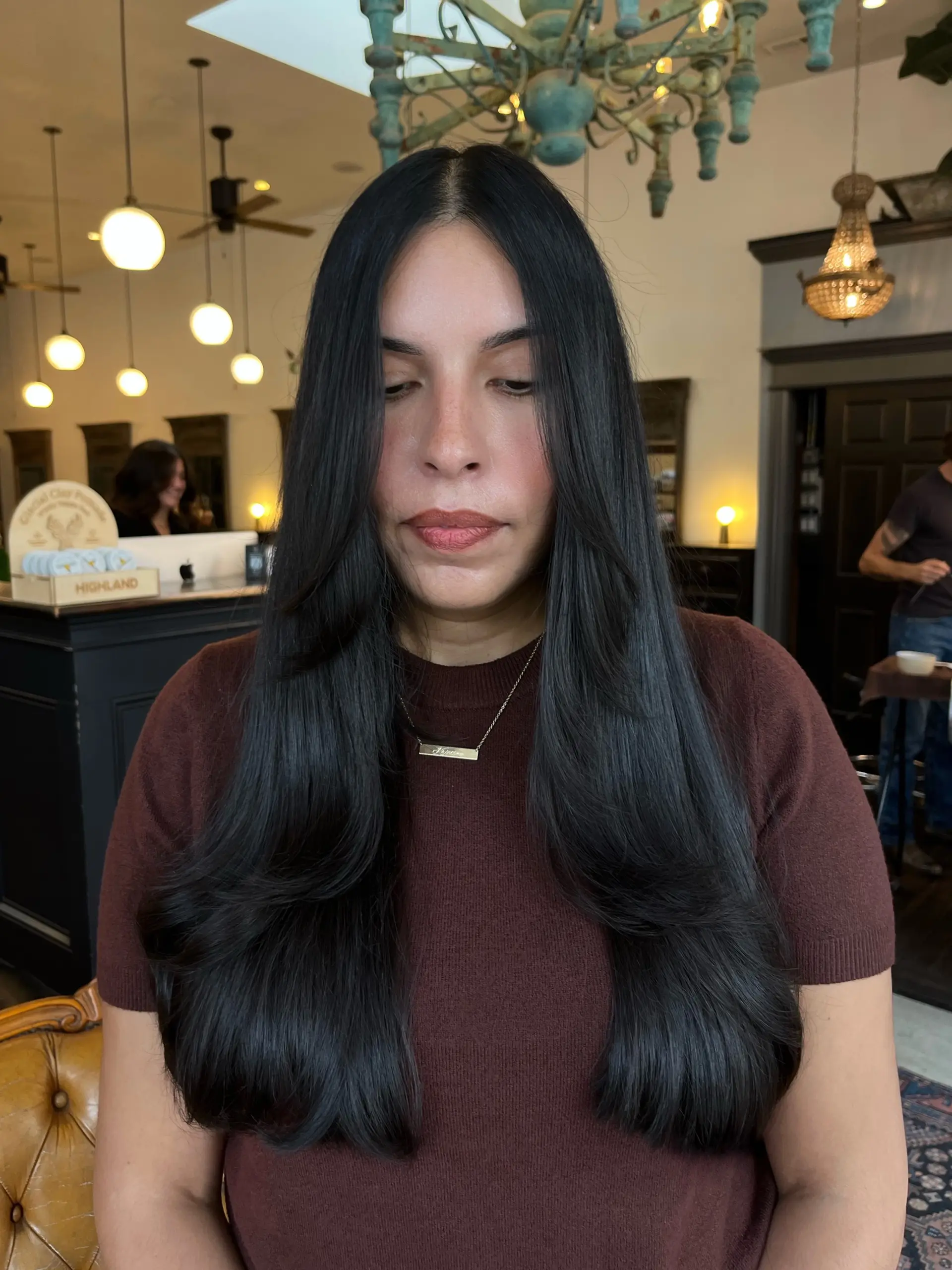 Long, glossy black hair featuring smooth face-framing layers and softly curved ends. 1