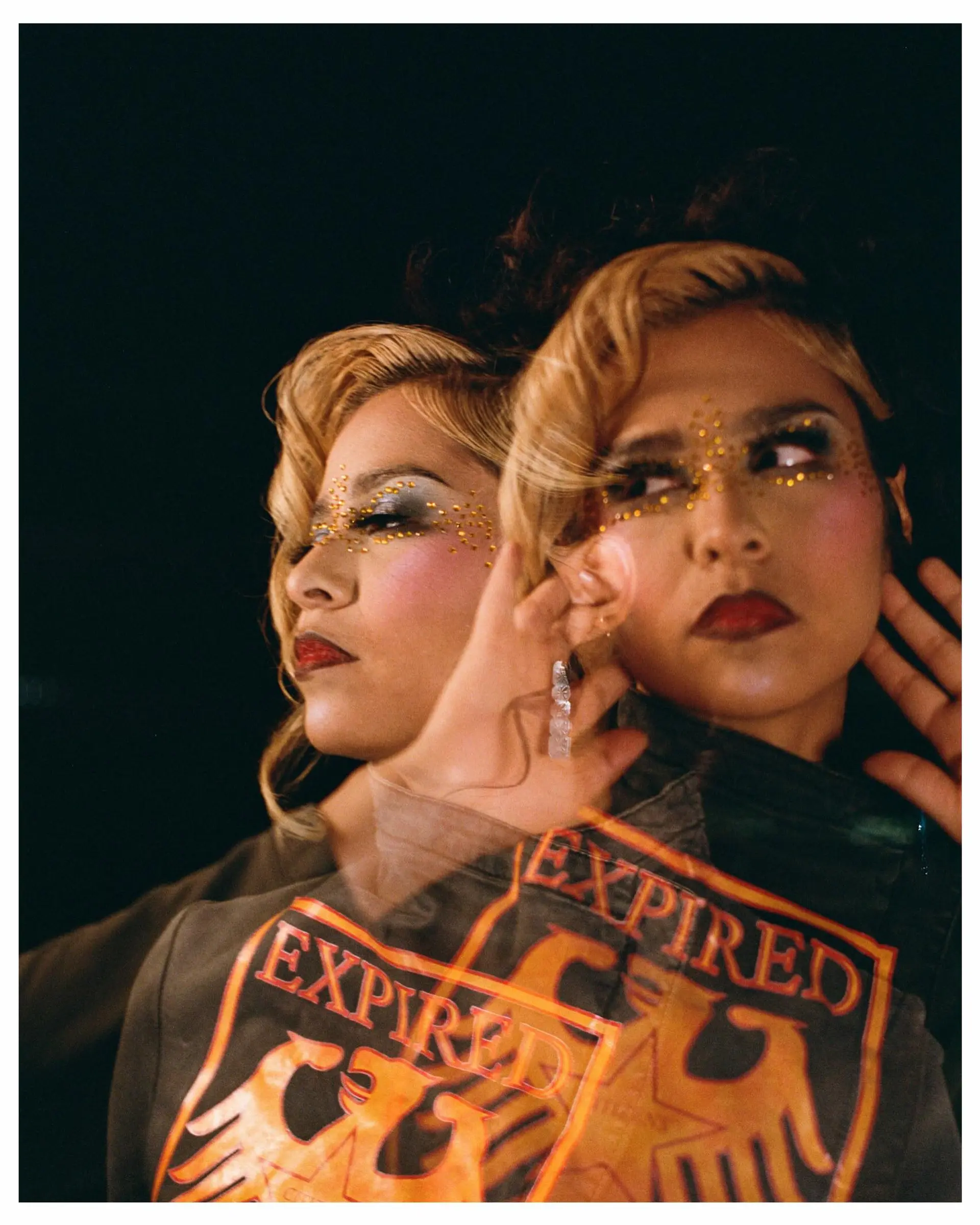 Vintage-inspired editorial retro waves styled in warm golden blonde with contrasting dark roots. 1