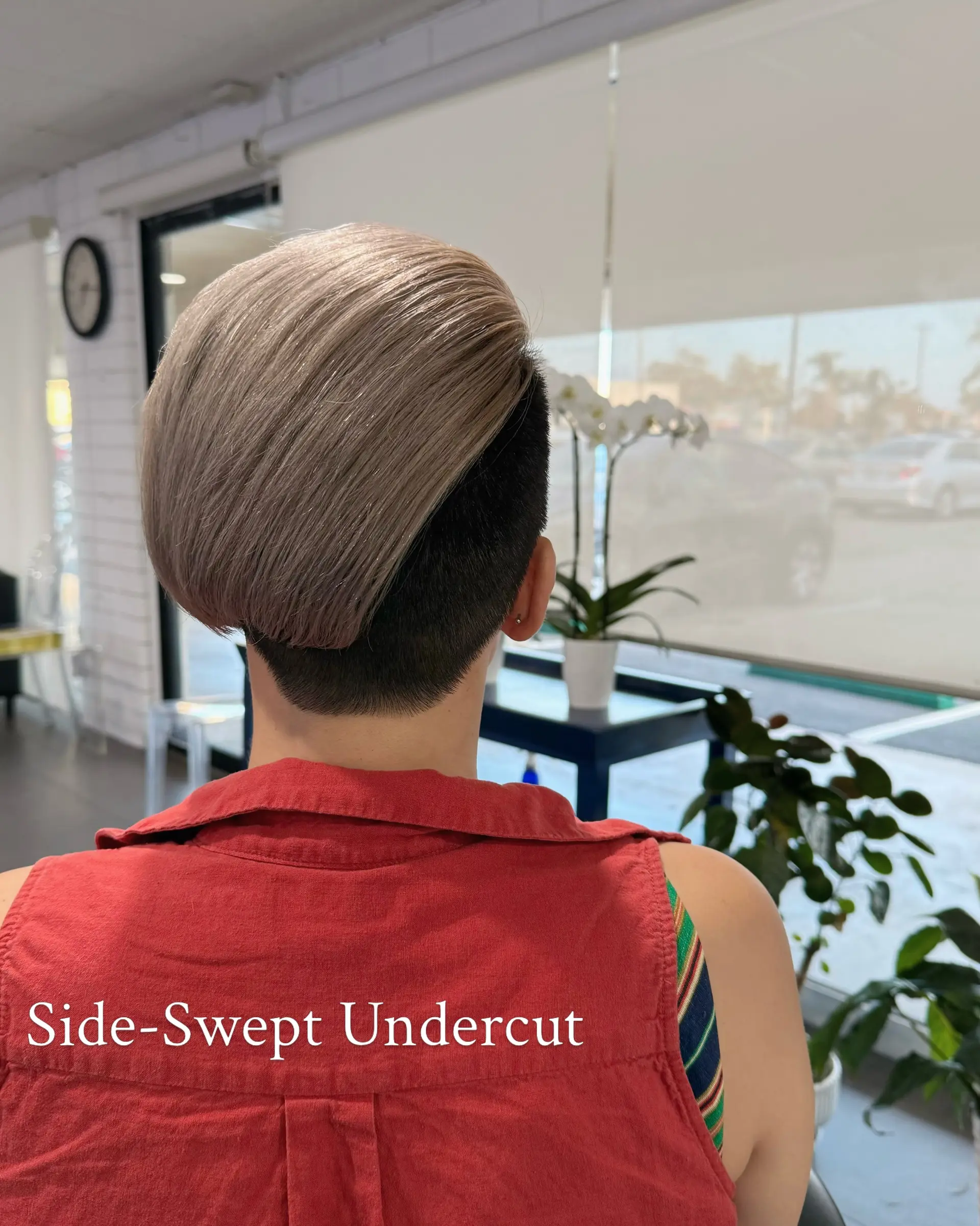 A sleek side-swept undercut with a smooth, rounded top section layered over tightly cropped dark sides and nape. 1