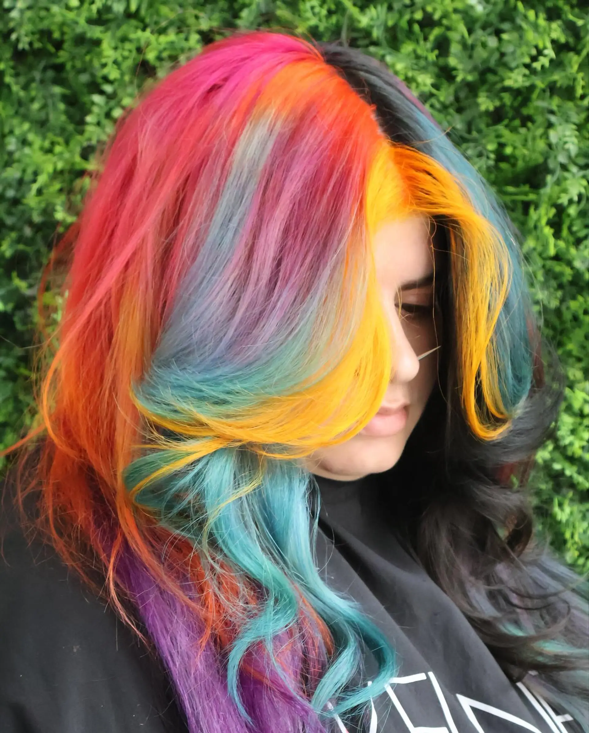 A long, wavy hairstyle with a rainbow balayage effect. 3