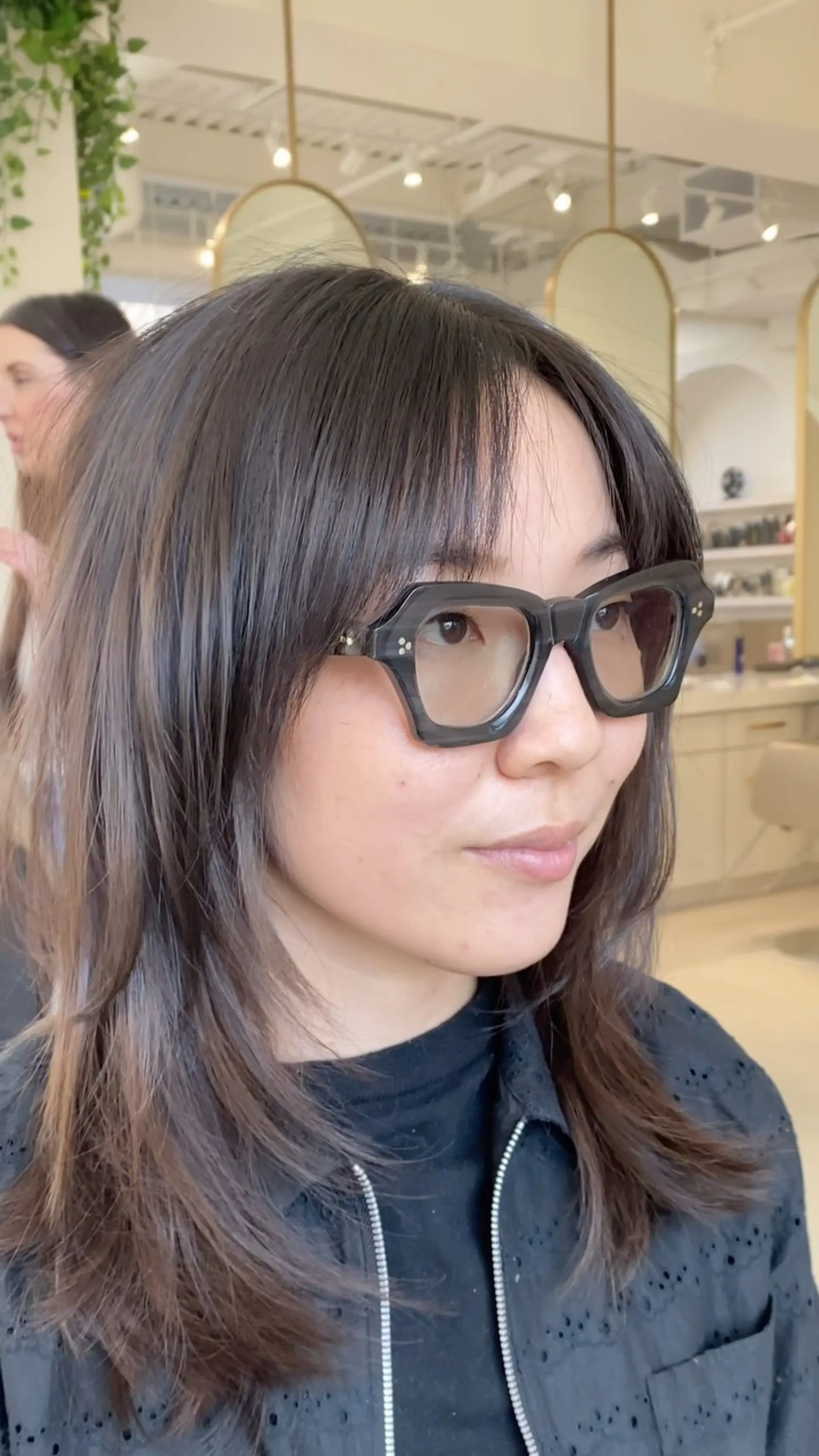 Medium-length layered haircut featuring wispy front bangs and textured face-framing layers. 1
