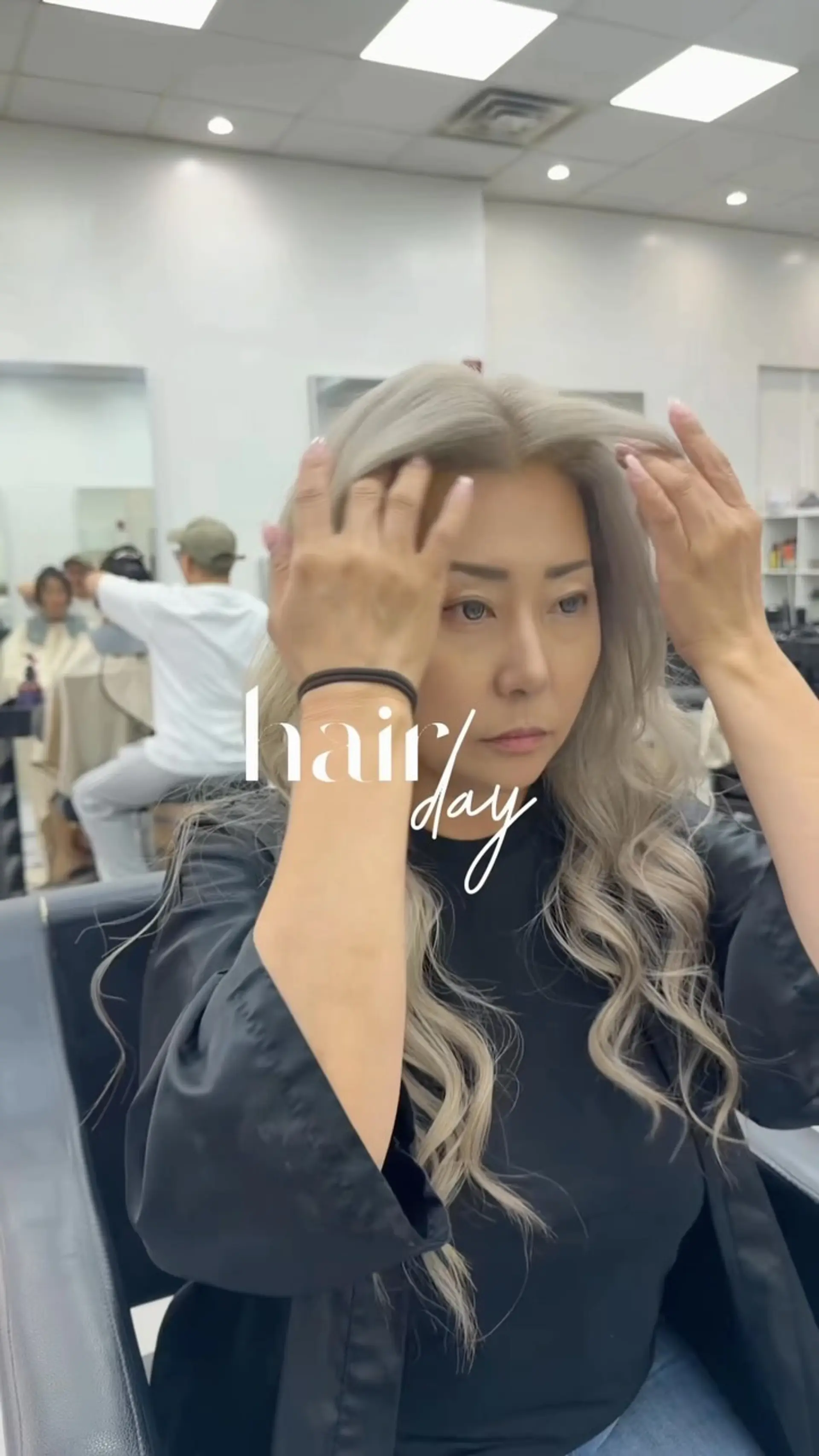 Long ash platinum blonde hair styled in soft, loose cascading waves with high-volume roots. 1