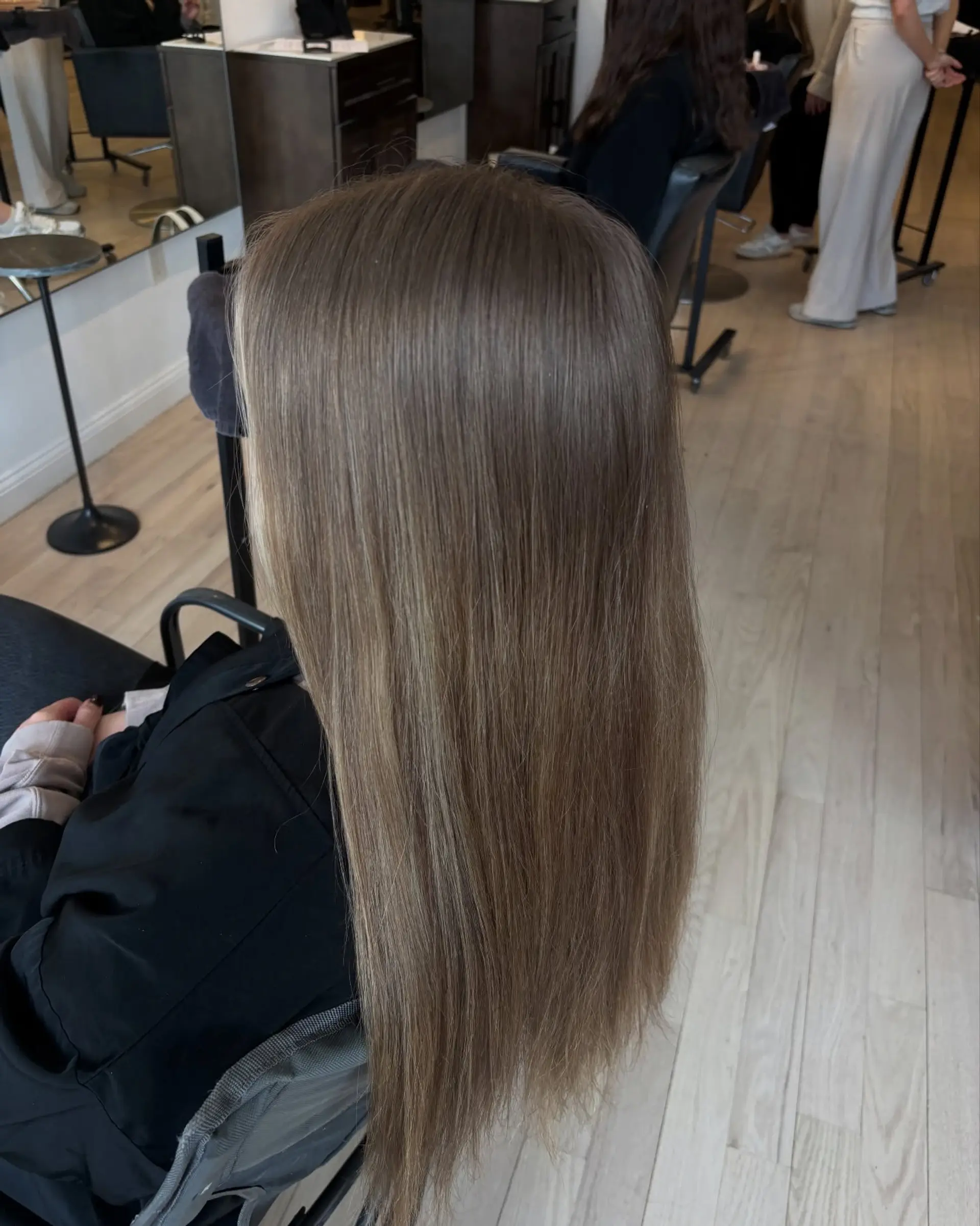 Long, sleek straight hair with a cool-toned light brown base and fine dimensional highlights. 1