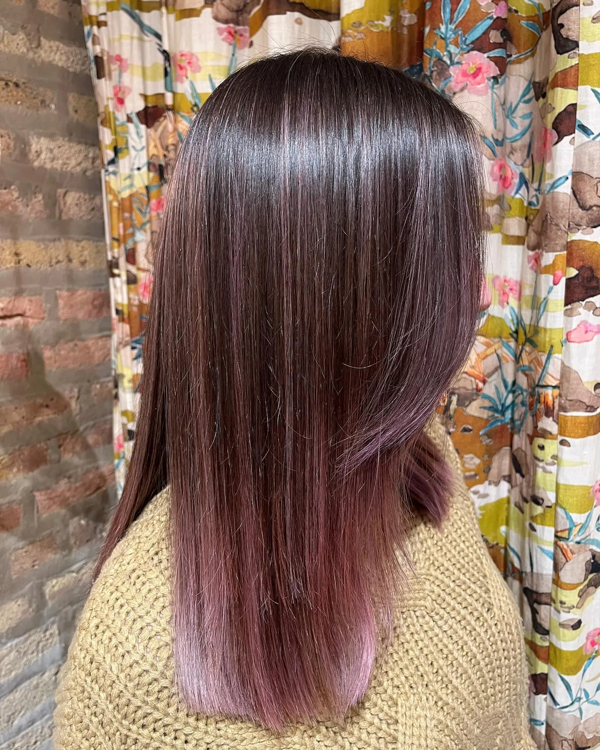 A long, straight hairstyle with a vibrant ombre color melt from mahogany to plum and pink. 1