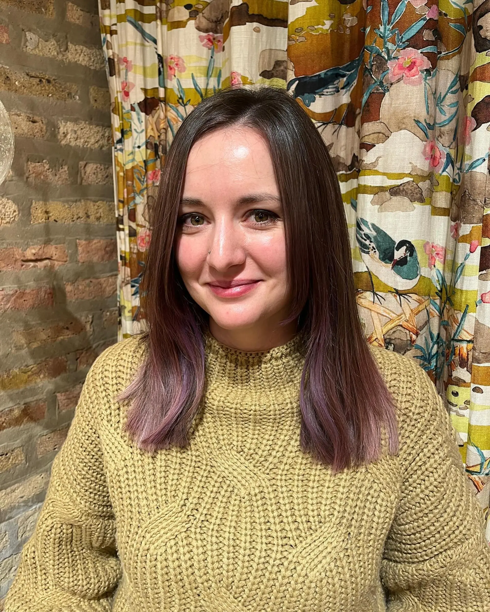 A long, straight hairstyle with a vibrant ombre color melt from mahogany to plum and pink. 2