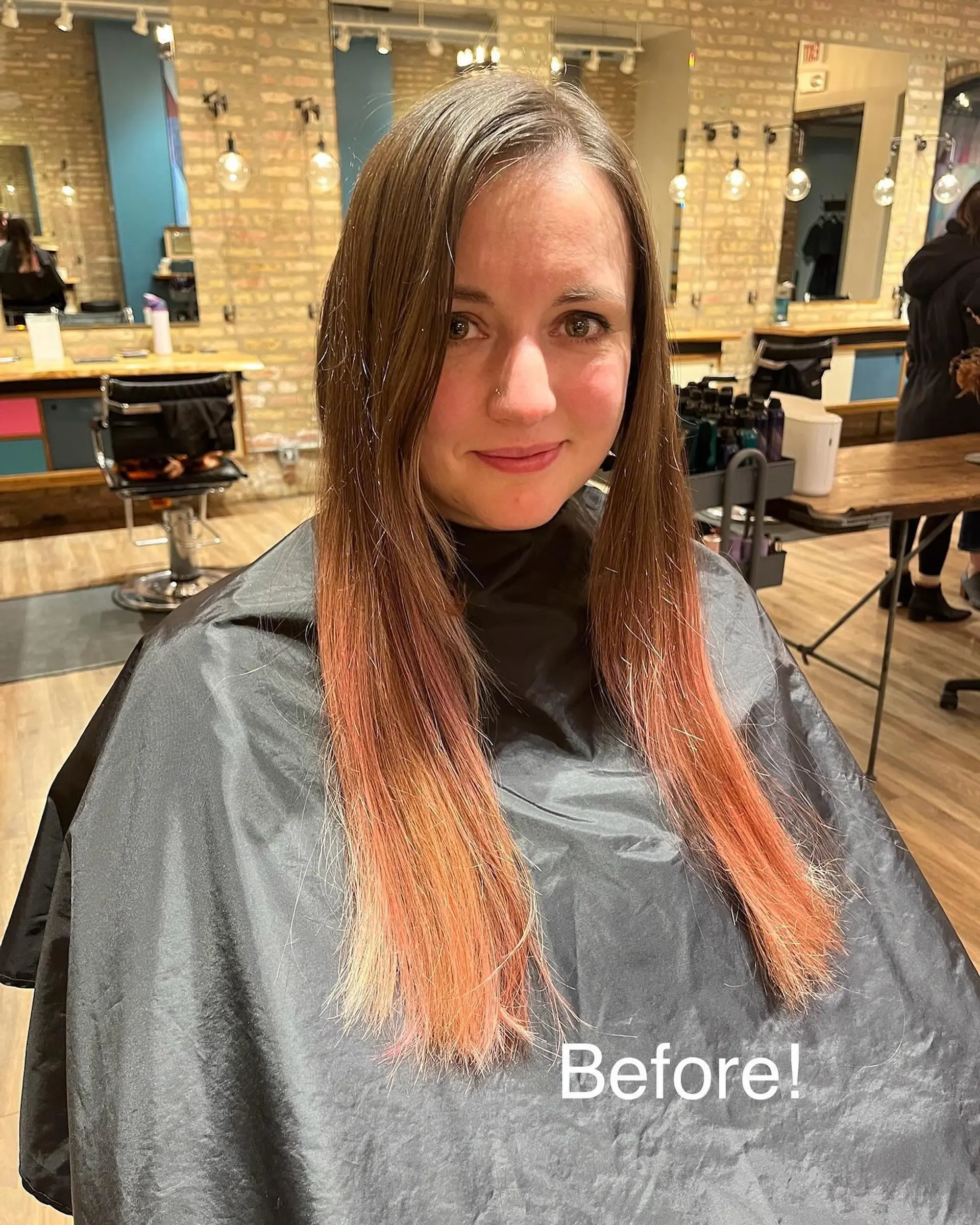 A long, straight hairstyle with a vibrant ombre color melt from mahogany to plum and pink. 3