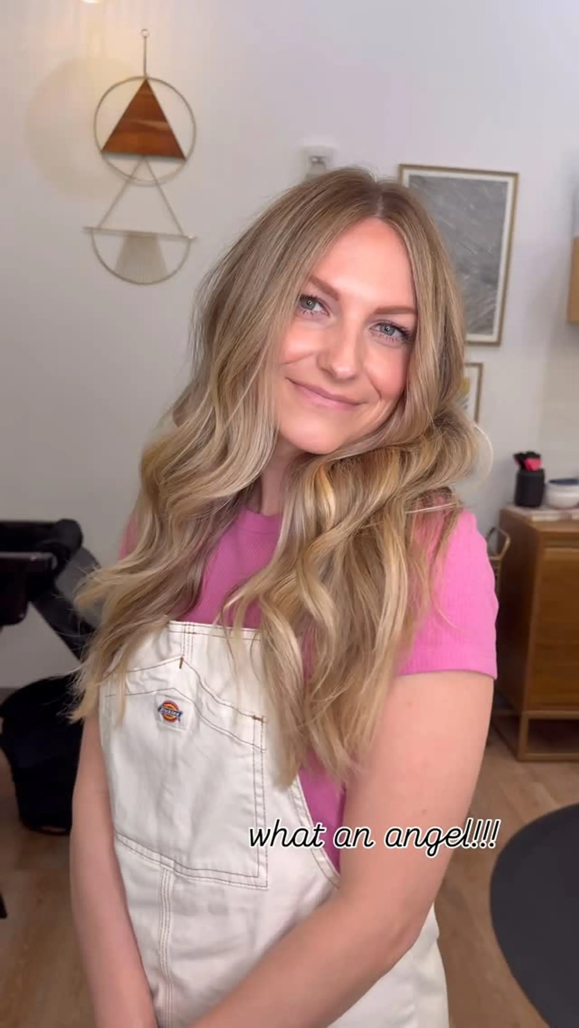 Soft, natural lived-in blonde balayage styled with gentle loose waves and a center part. 1