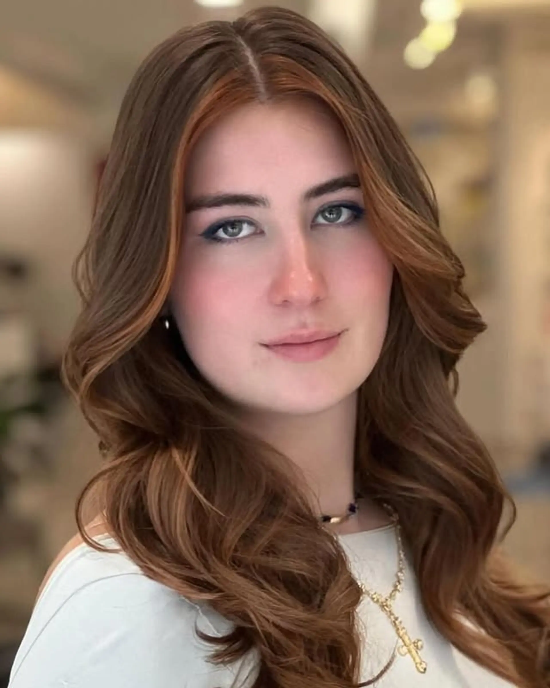 Long wavy hair with copper balayage highlights. 1