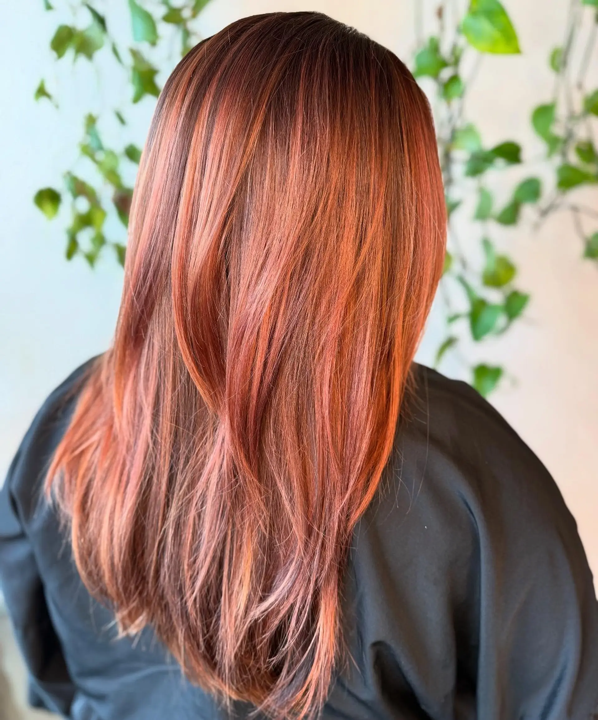 Long, straight hair featuring a blend of warm rose gold and copper hues with soft layered ends. 1