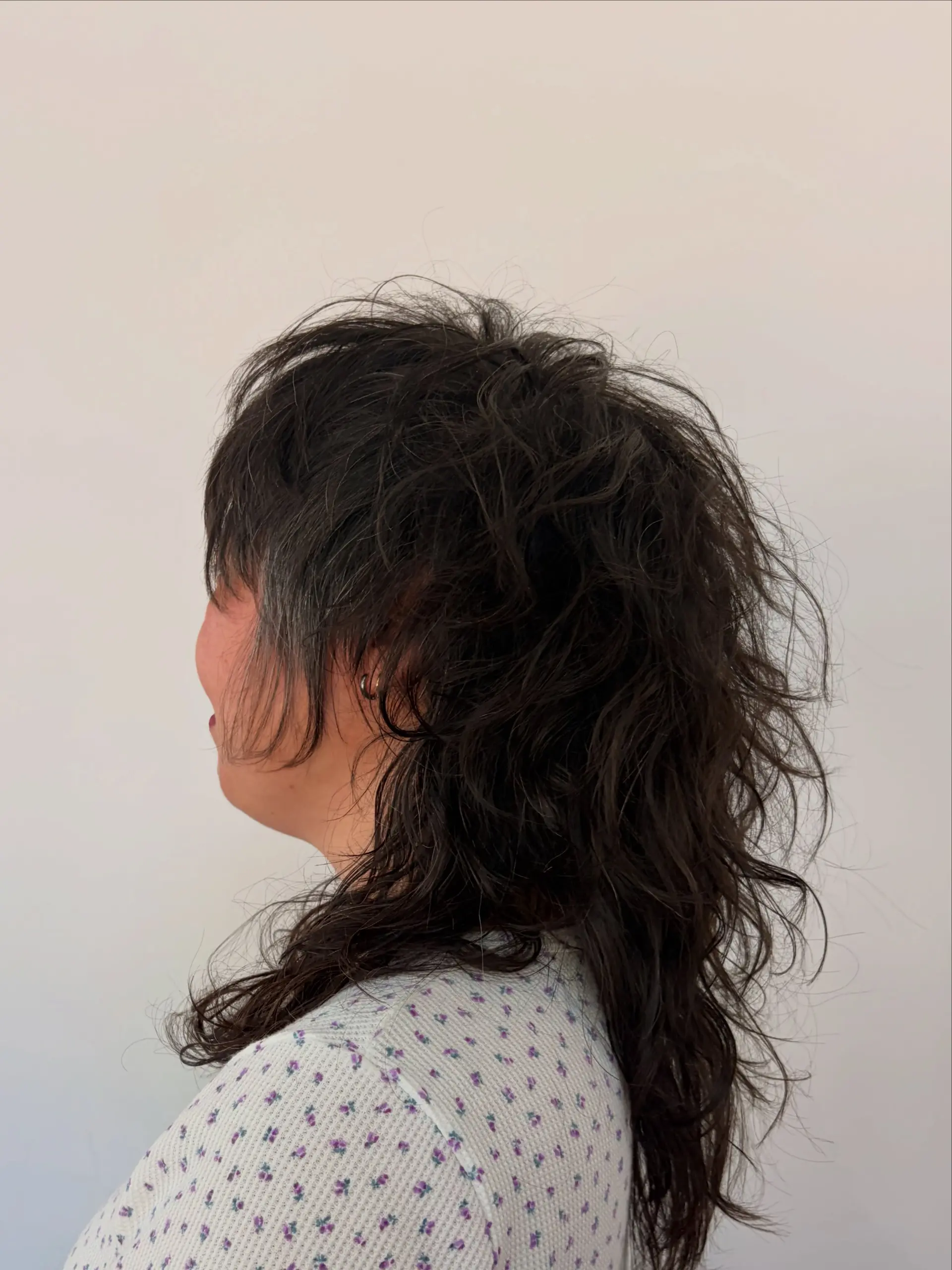 A textured medium-length shag haircut featuring tousled natural waves, choppy layers, and face-framing pieces. 1