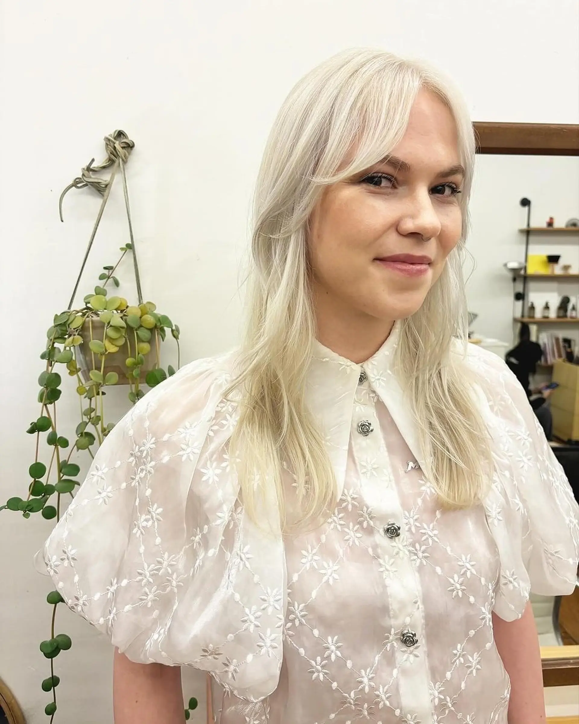 Long, wavy, platinum blonde hair with a side part and face-framing layers, featuring soft waves and a smooth, shiny texture. Haircut and color by @kotomiacacio__hair 2