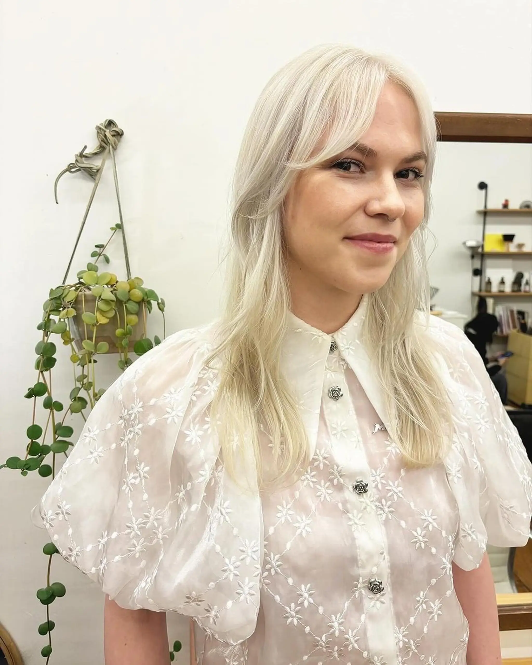 Long, wavy, platinum blonde hair with a side part and face-framing layers, featuring soft waves and a smooth, shiny texture. Haircut and color by @kotomiacacio__hair 2