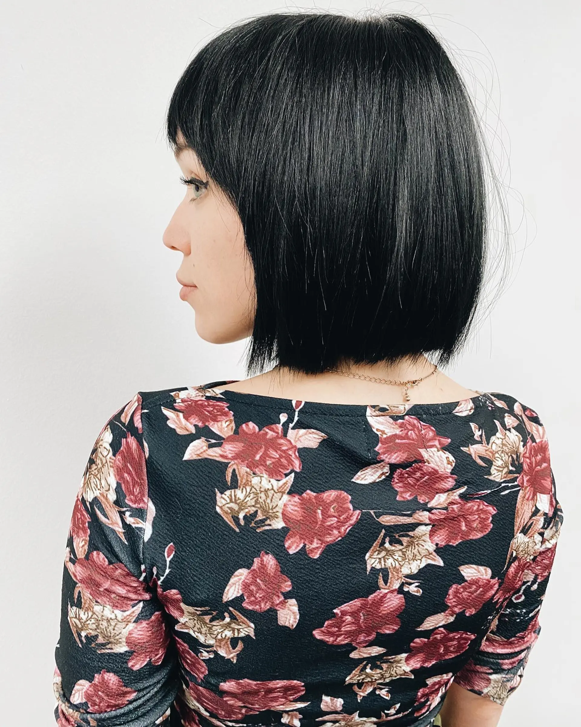 A sleek chin-length black bob with lightly textured ends and classic fringe bangs. 1